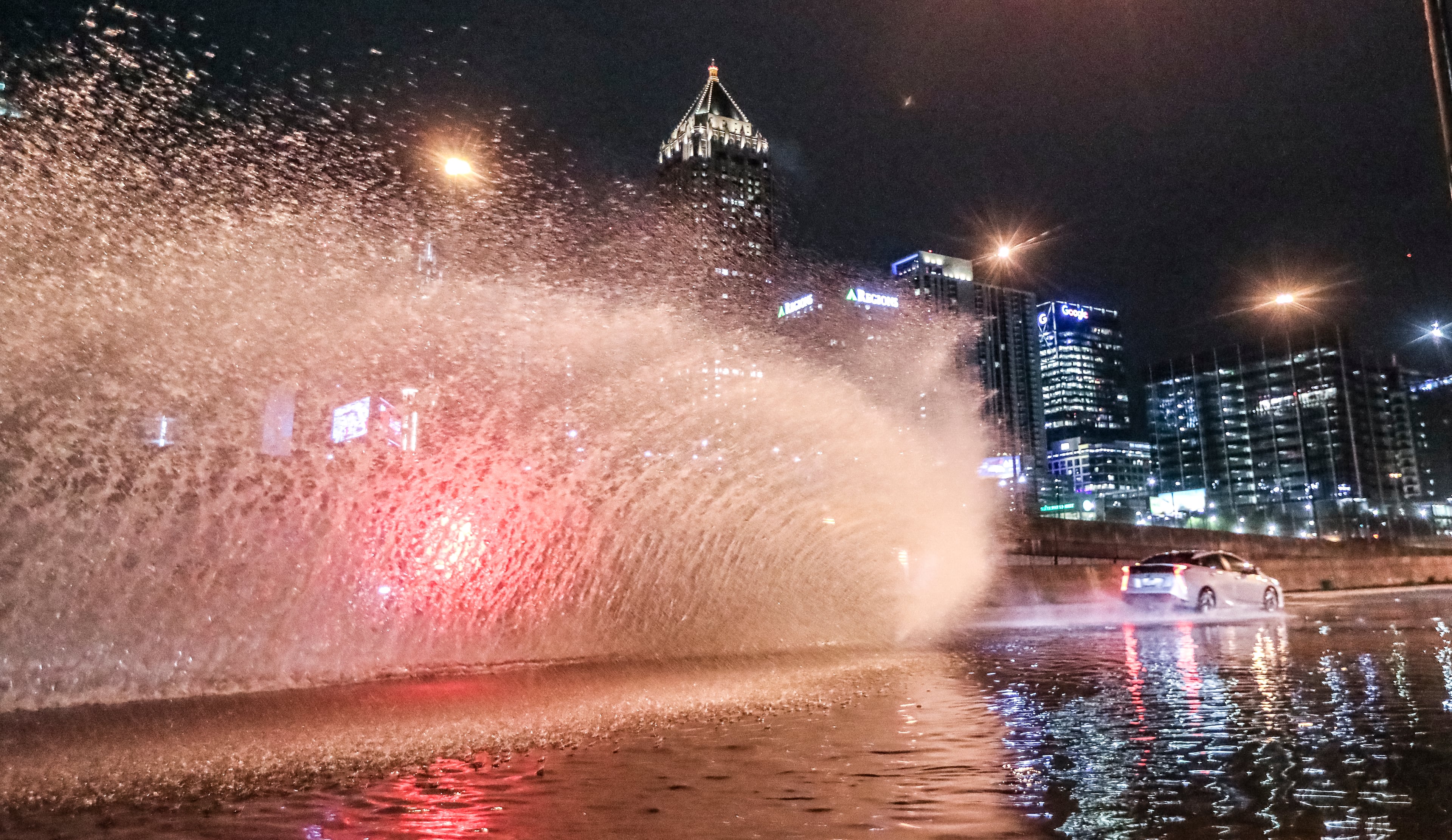 Motorists plow through standing water along Techwood Drive near 16th Street Monday morning, March 27, 2023 during early morning thunderstorms in Atlanta. (John Spink / John.Spink@ajc.com)