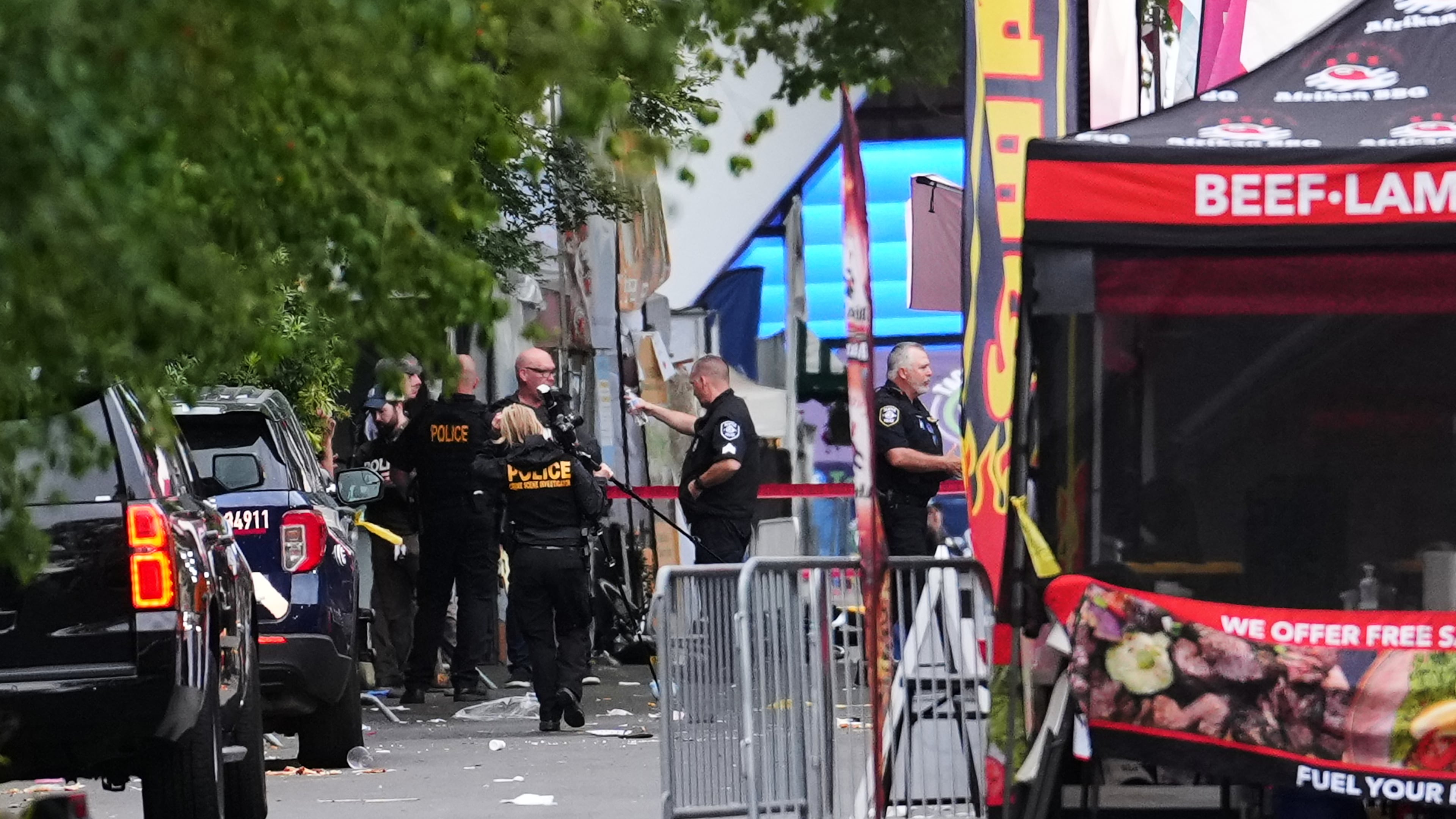 A crime scene photographer arrives as law enforcement examines the scene following a shooting at Seattle Center during the Bite of Seattle food festival Sunday, July 26, 2026, in Seattle. (AP Photo/Lindsey Wasson)