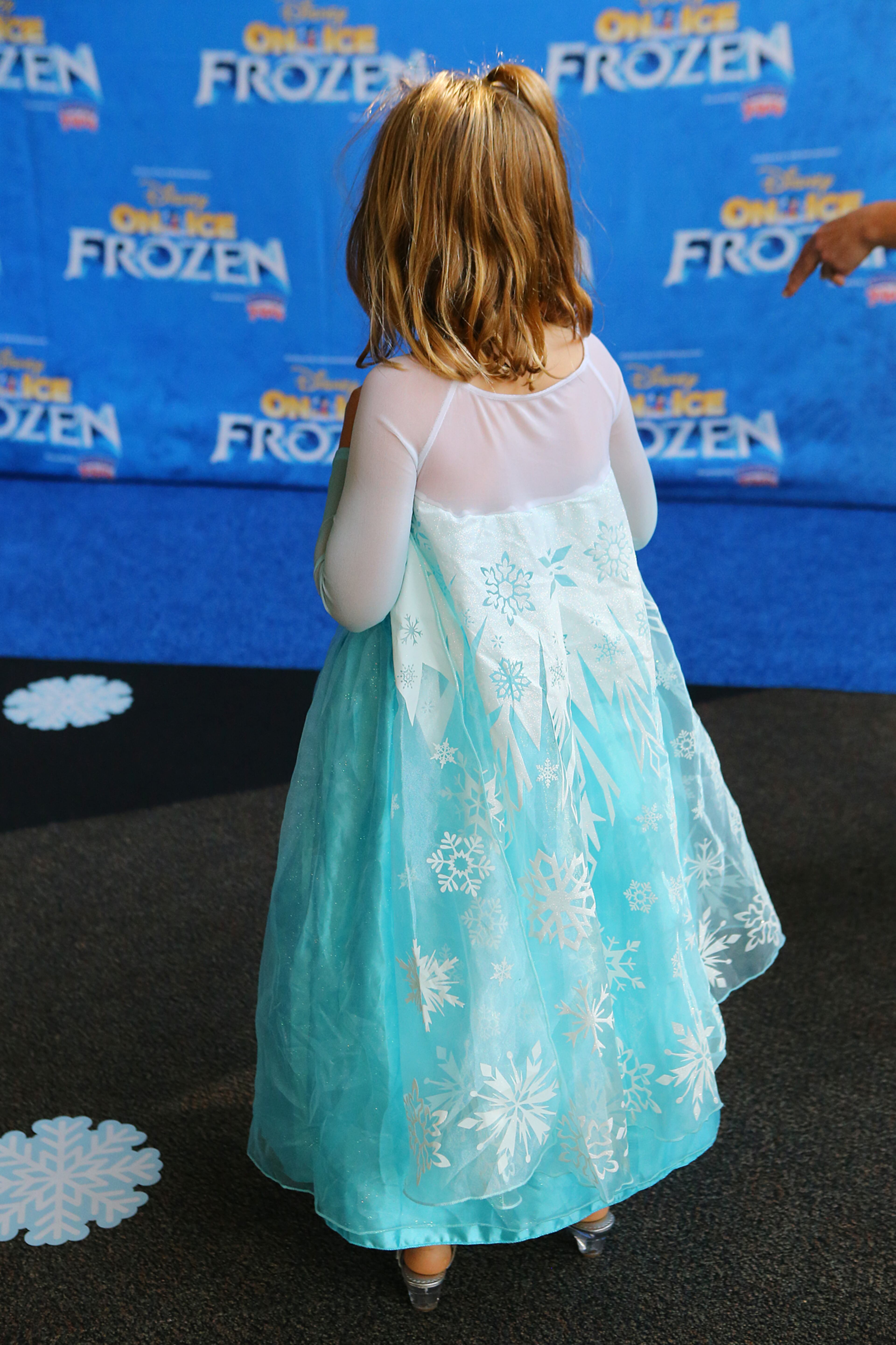 Alexandra Talbert, 3, sports her long blue snowflake princess dress arriving on the blue carpet for Disney On Ice presents Frozen at Philips Arena on Wednesday, Oct. 8, 2014, in Atlanta.