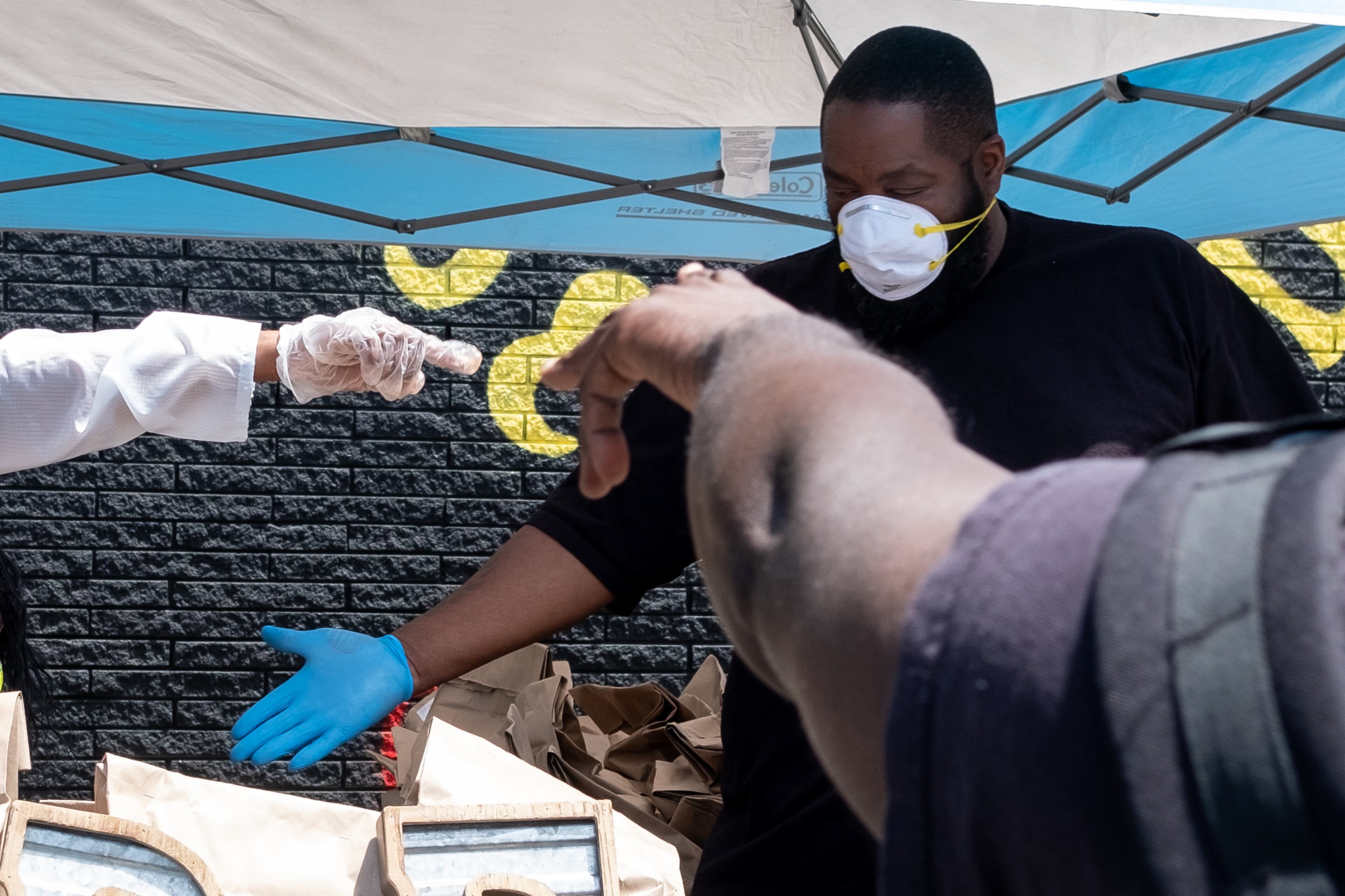 200506-Atlanta- Niya Woods reacts as T.I. walks up her driveway to surprise her with hygiene supplies and $500 Wednesday afternoon May 6, 2020. T.I. and Killer Mike made the surprise deliveries and shared the news that two-weeks of groceries were on the way to five families served by PAWkids, a childrenâs enrichment program. Ben@BenGray.com for the Atlanta Journal Constitution