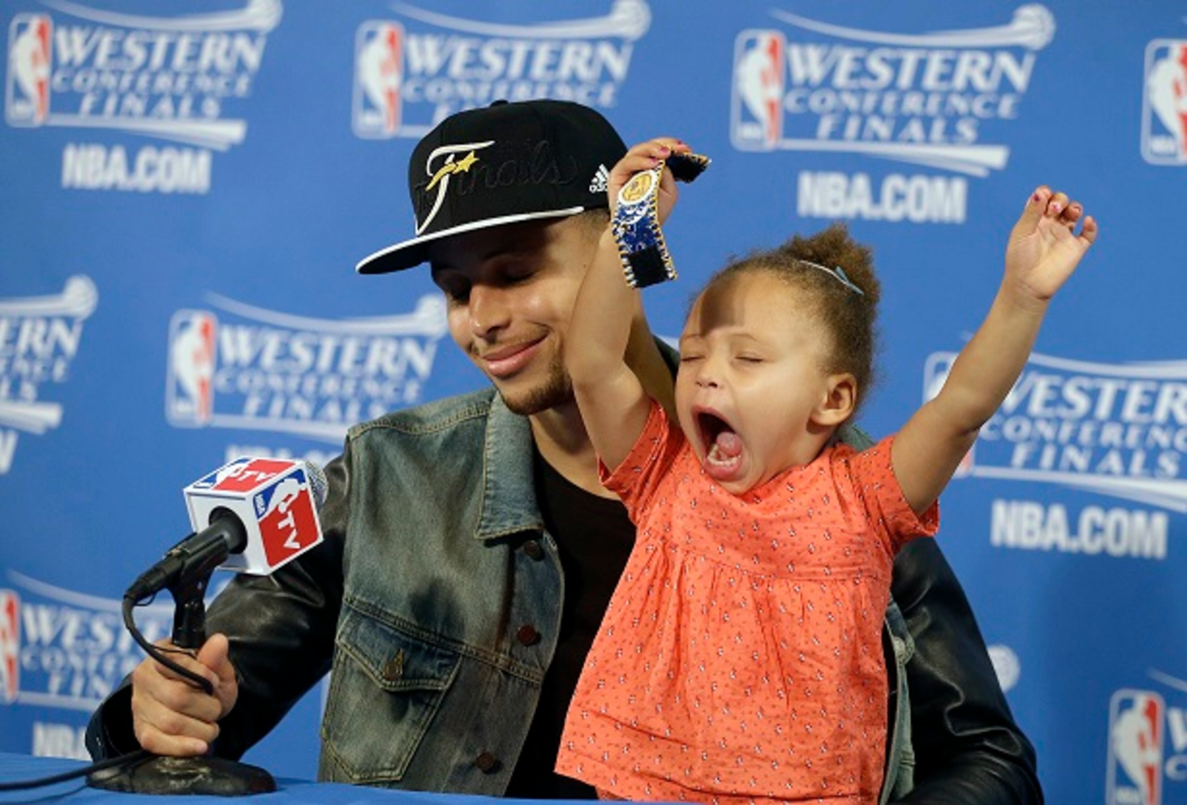 Golden State Warriors guard Stephen Curry is joined by his daughter Riley at a news conference after Game 5 of the NBA basketball Western Conference finals against the Houston Rockets in Oakland, Calif., Wednesday, May 27, 2015. The Warriors won 104-90 and advanced to the NBA Finals. (AP Photo/Ben Margot)