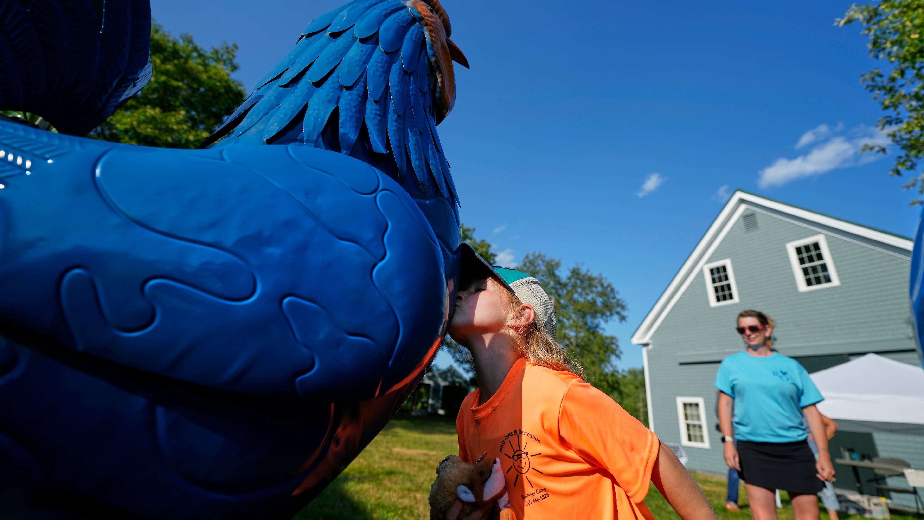 Pyper Leblanc kisses a tin rooster goodbye after a visit to the Hilton Winn Farm in Ogunquit, Maine, Wednesday, July 22, 2026. (AP Photo/Robert F. Bukaty)