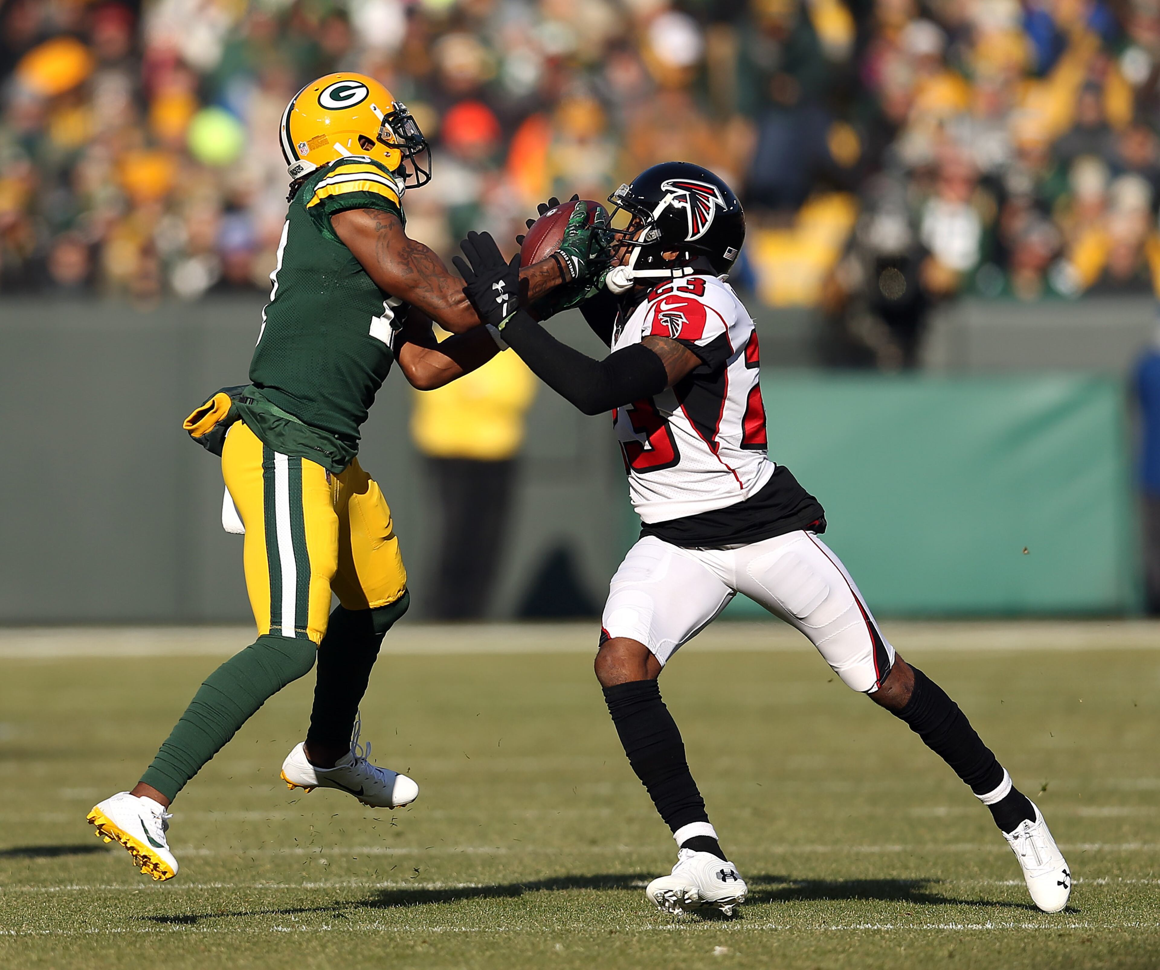 GREEN BAY, WISCONSIN - DECEMBER 09: Davante Adams #17 of the Green Bay Packers catches a pass over Robert Alford #23 of the Atlanta Falcons during the first half of a game at Lambeau Field on December 09, 2018 in Green Bay, Wisconsin. (Photo by Dylan Buell/Getty Images)