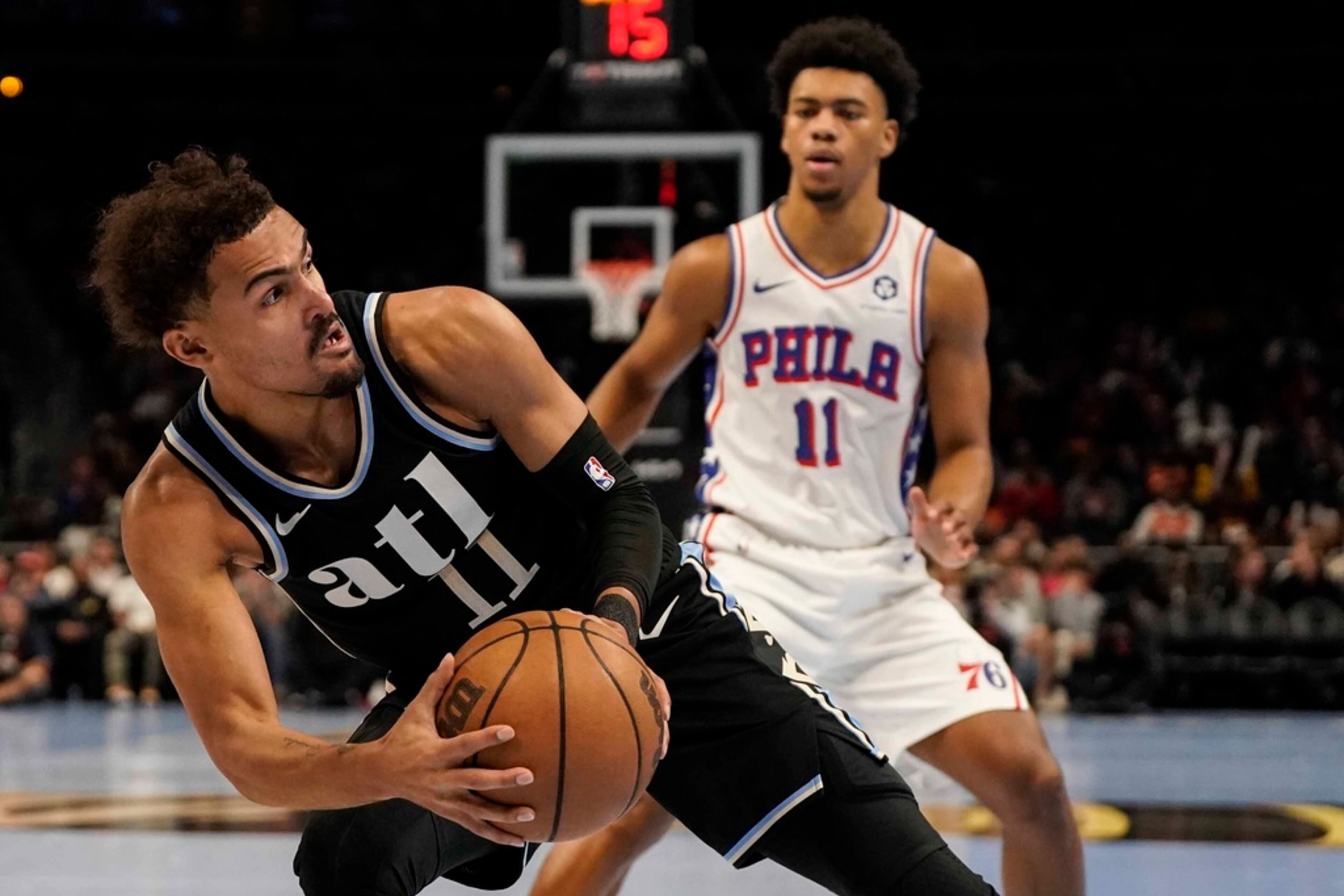 Atlanta Hawks guard Trae Young (11) works against Philadelphia 76ers guard Jaden Springer (11) during the first half of an In-Season Tournament NBA basketball game, Friday, Nov. 17, 2023, in Atlanta. (AP Photo/Mike Stewart)