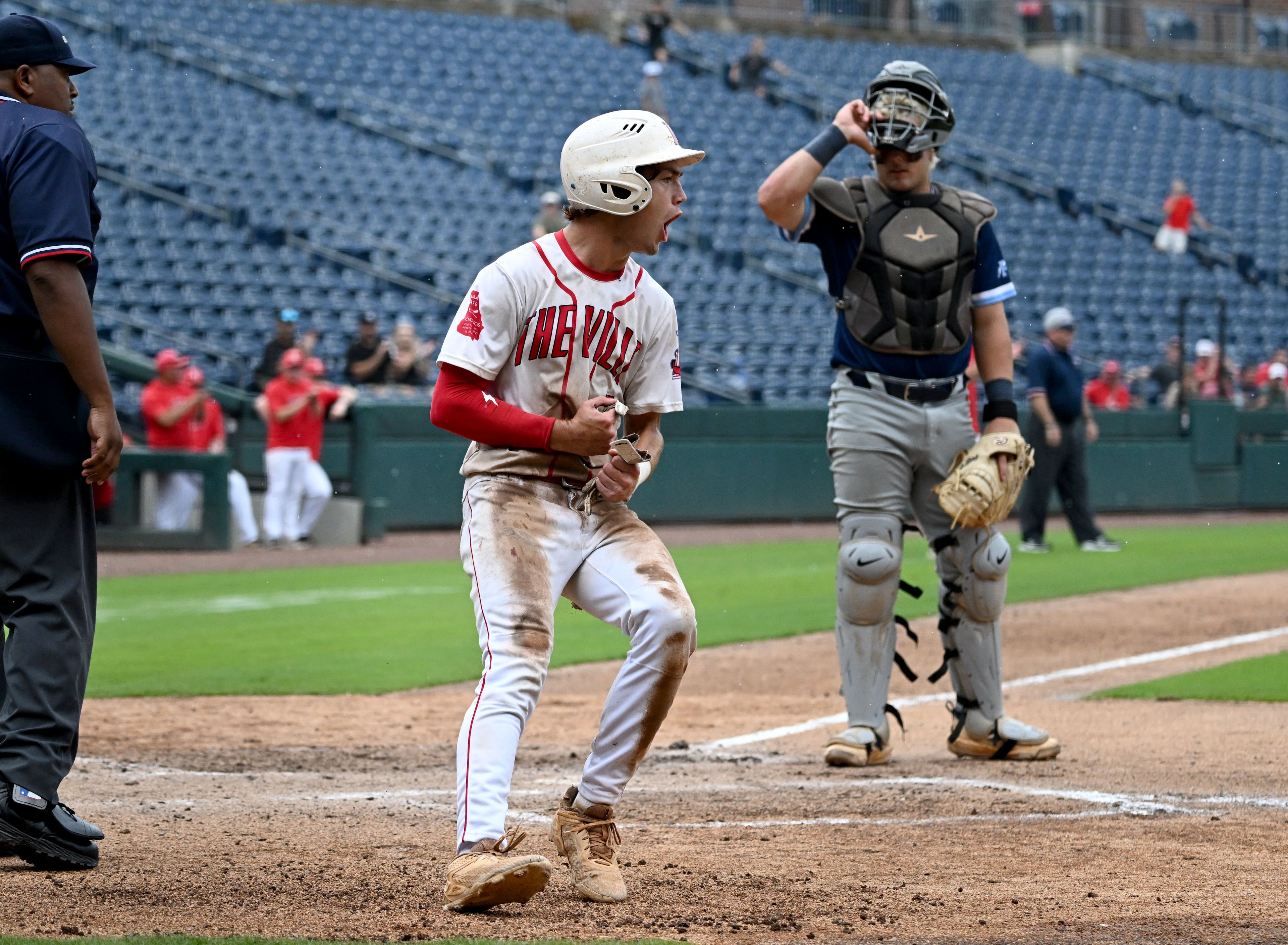 Loganville's Brantley Carter reacts after scoring on a sacrifice by Jake Boland (not pictured) during the sixth inning of Game 1 of the GHSA Class 5A baseball state championship series Monday, May 25, 2026, at Gwinnett Field in Lawrenceville. (Hyosub Shin/AJC)