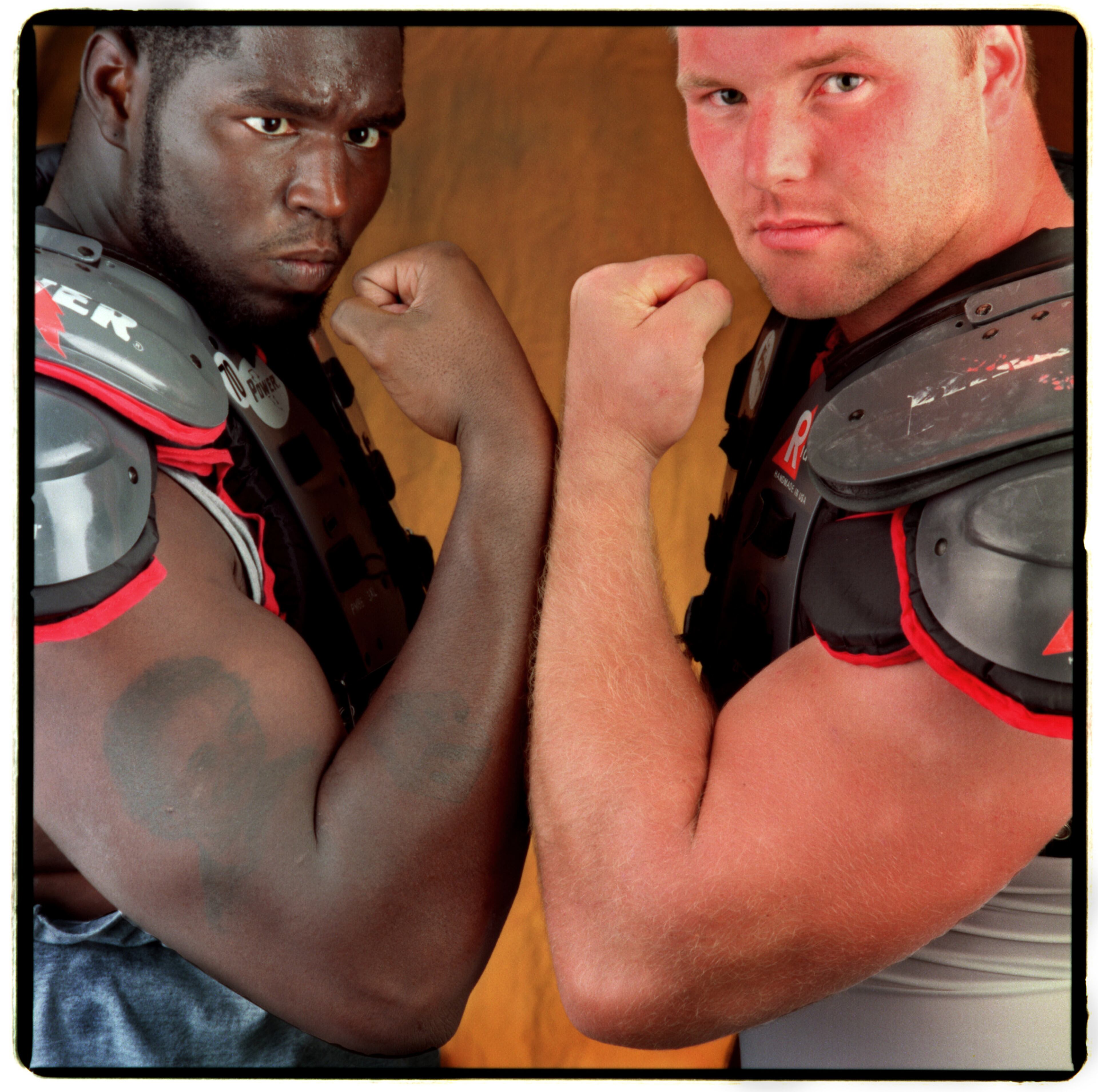 Falcons players Bob Whitfield (left) and Travis Hall show off their muscles. (AJC Staff Photo/Joey Ivansco)