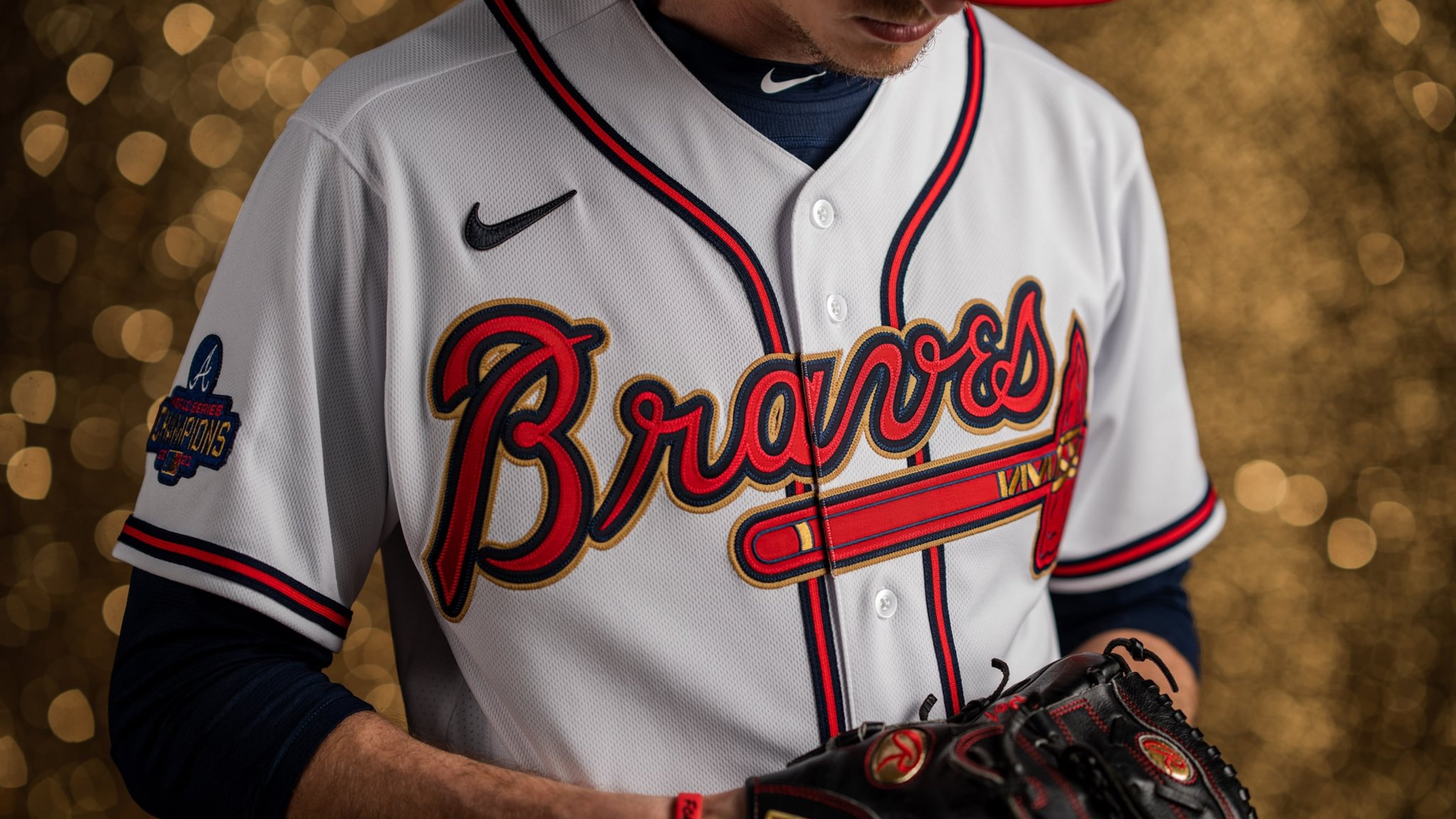 The jerseys for the season's first homestand include gold outlines around the "Braves" script and tomahawk and a World Series Champions patch on the right sleeve with the word CHAMPIONS capitalized in gold.