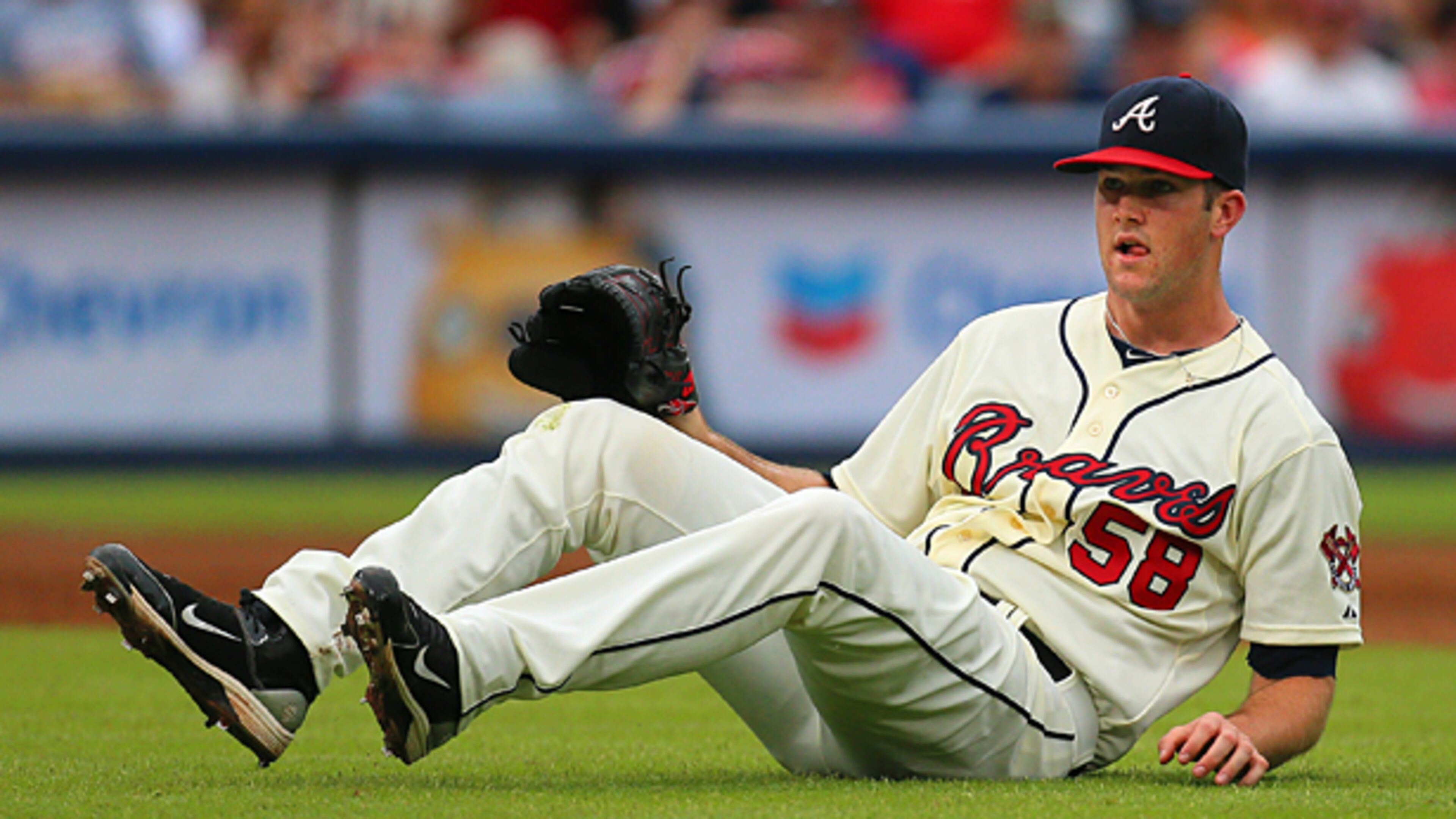 090113 Atlanta: - DOWN AND OUT -- Braves pitcher Alex Wood hits the ground on a ground ball by Marlins Giancarlo Stanton to short stop Andrelton Simmons during the second inning in their MLB baseball game on Sunday, Sept. 1, 2013, in Atlanta. Woods was pulled in the third inning trailing the Marlins 7-0.