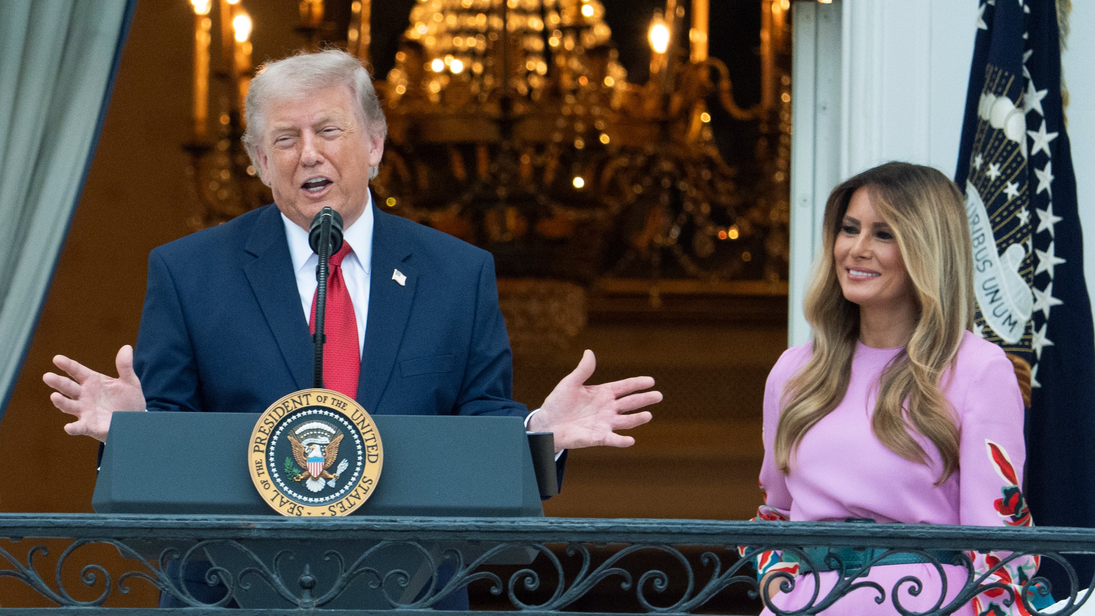 President Donald Trump with first lady Melania Trump addresses the attendees from the Blue Room Balcony of the White House during the annual Congressional Picnic on the South Lawn, Tuesday, May 19, 2026, in Washington. (AP Photo/Manuel Balce Ceneta)