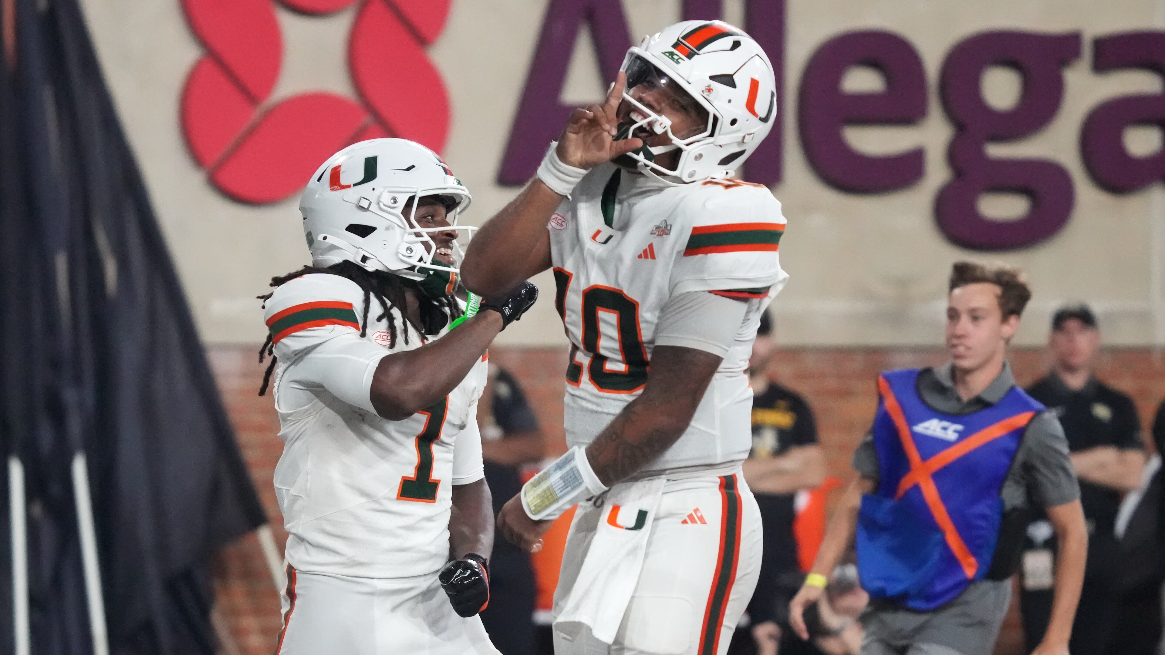 Miami quarterback Darian Mensah (10) and wide receiver Malachi Toney (1) celebrate after Toney's touchdown against Wake Forest during the second half of an NCAA college football game in Winston-Salem, N.C., Friday, Sept. 18, 2026. (AP Photo/Chuck Burton)