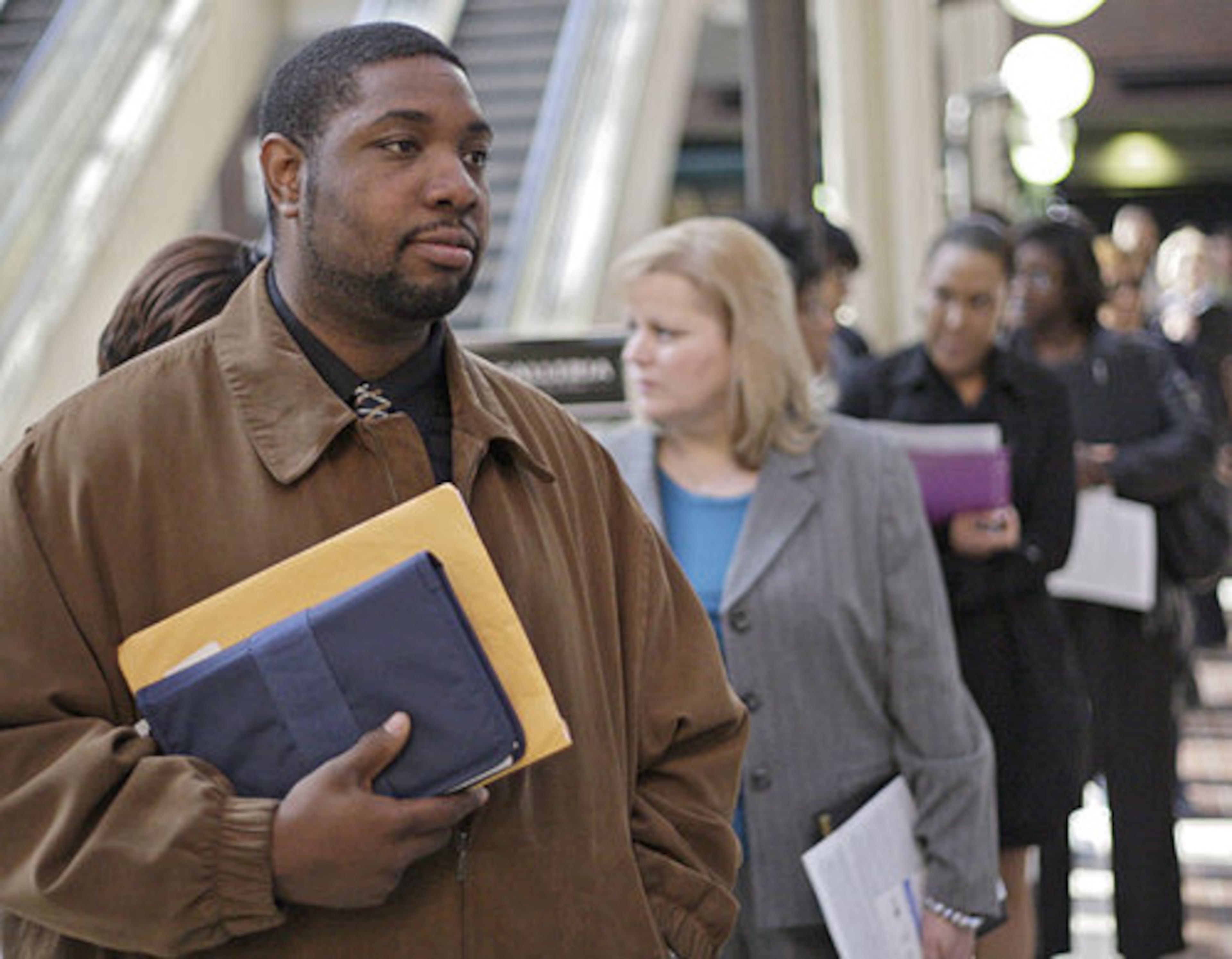 Robert Wilson, from Stone Mountain, waits in line for the job fair to open. He has been out of work for six months. He had been working as an installer for DirectTV.