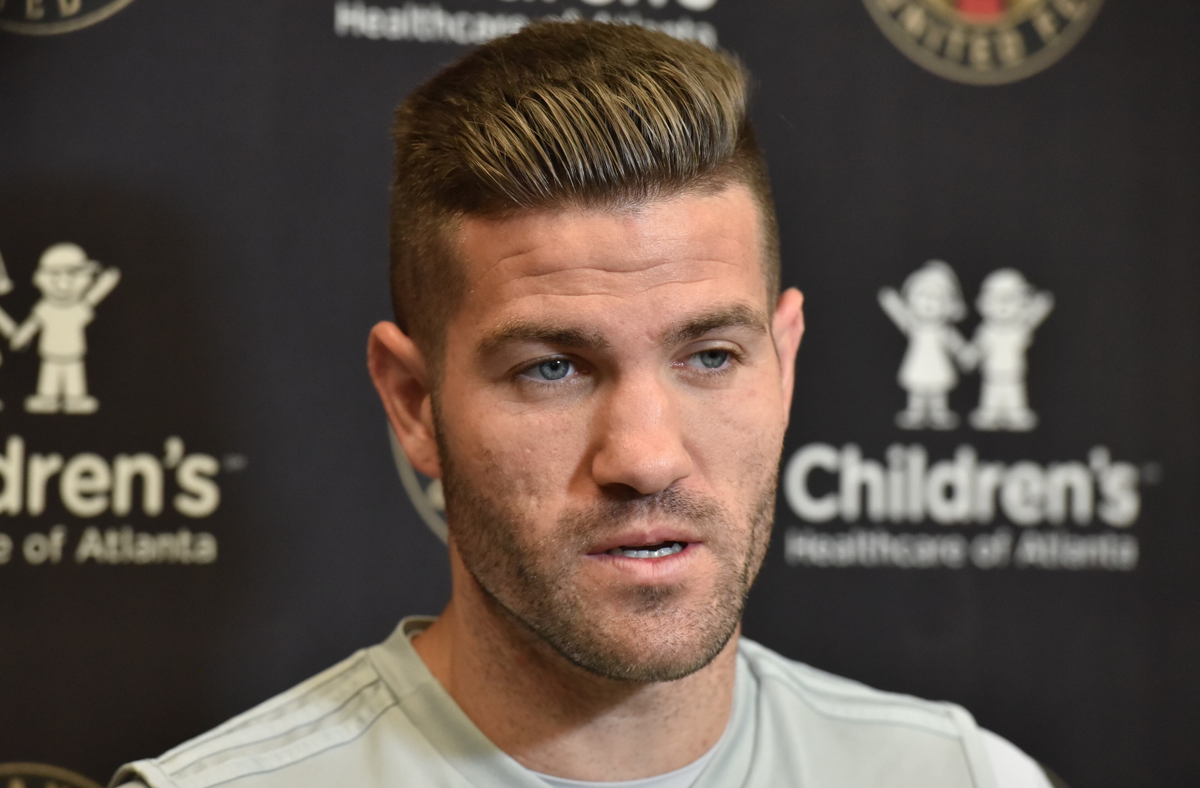 Defender Greg Garza speaks to members of the press prior to Tuesday's practice at Children's Healthcare of Atlanta Training Ground in Marietta. (Hyosub Shin/hshin@ajc.com)
