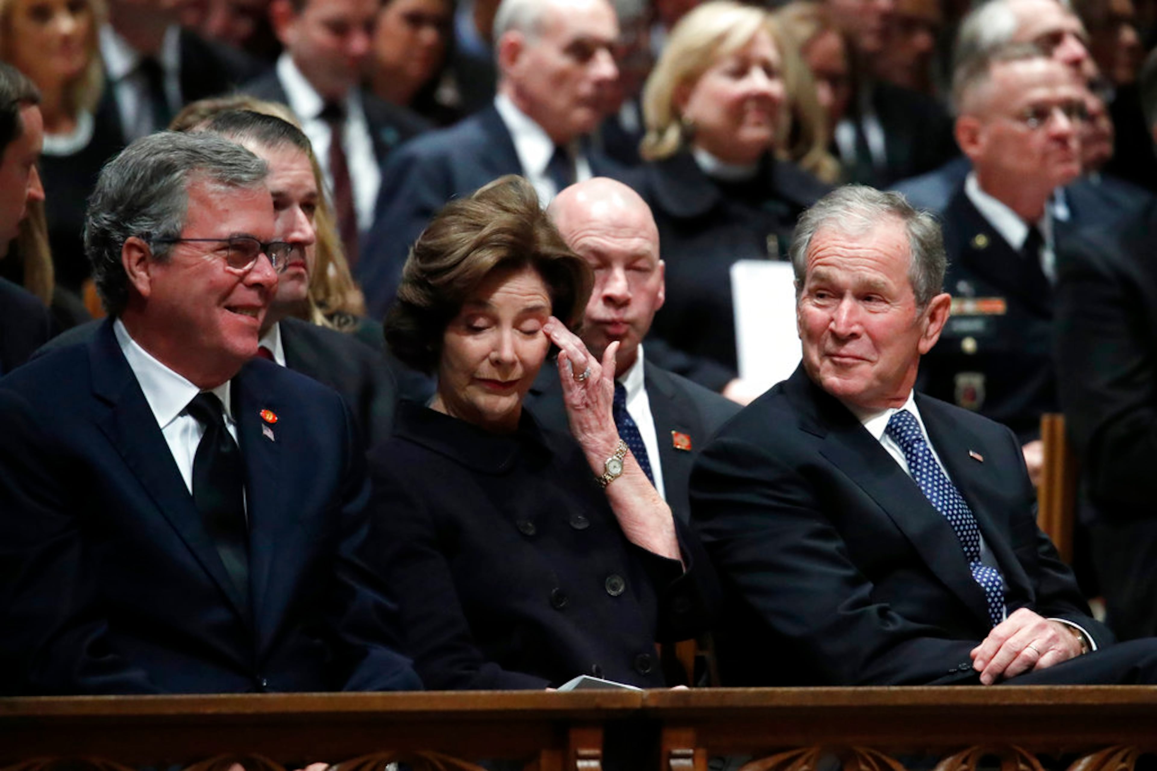 Former Florida Gov. Jeb Bush, Laura Bush and former President George W. Bush listen during a State Funeral for former President George H.W. Bush at the Washington National Cathedral, Wednesday, Dec. 5, 2018, in Washington.(AP Photo/Alex Brandon, Pool)