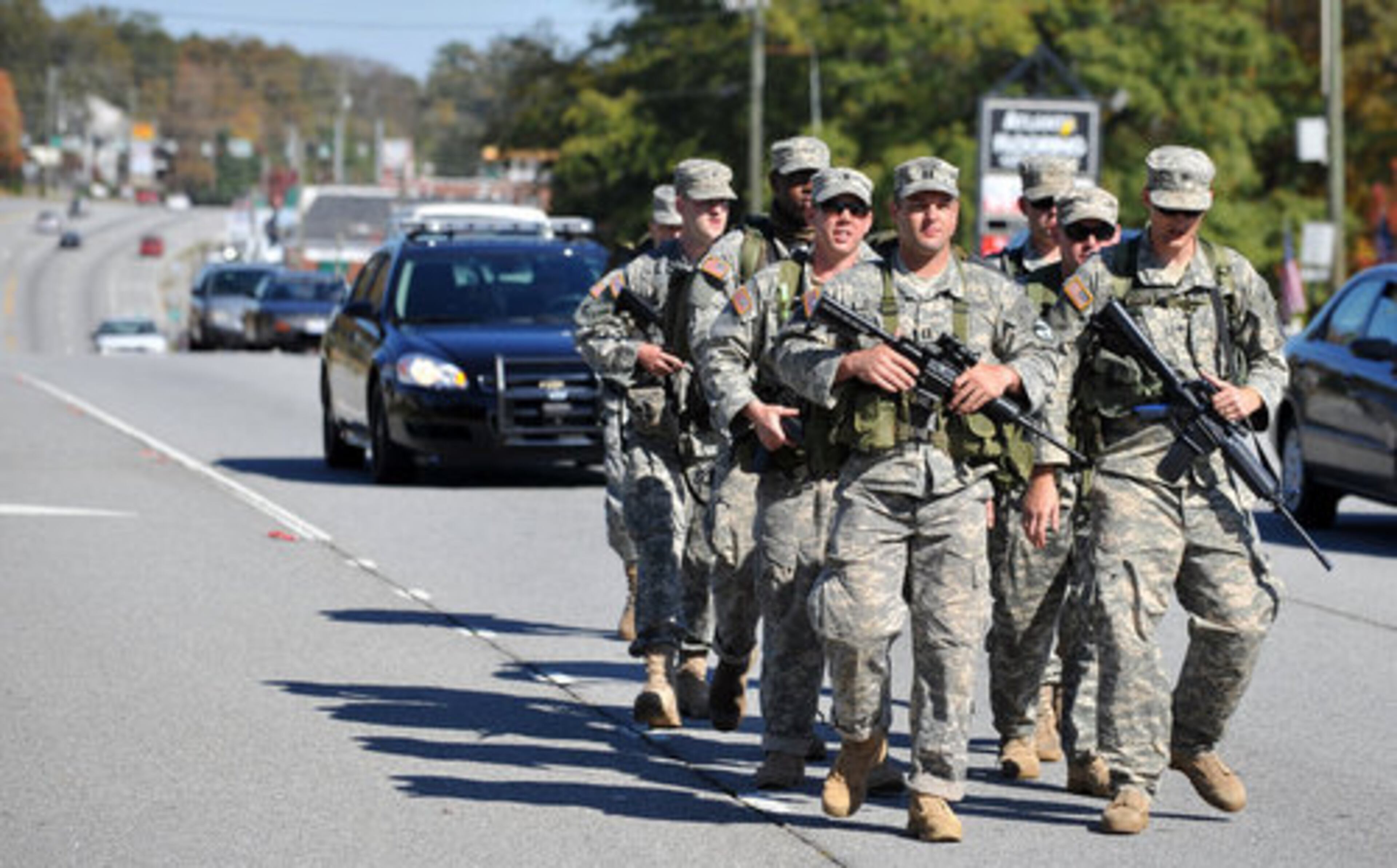 A police escort allows the soldiers to walk in the roadway for most of the trip. Shown here walking on Buford Highway.