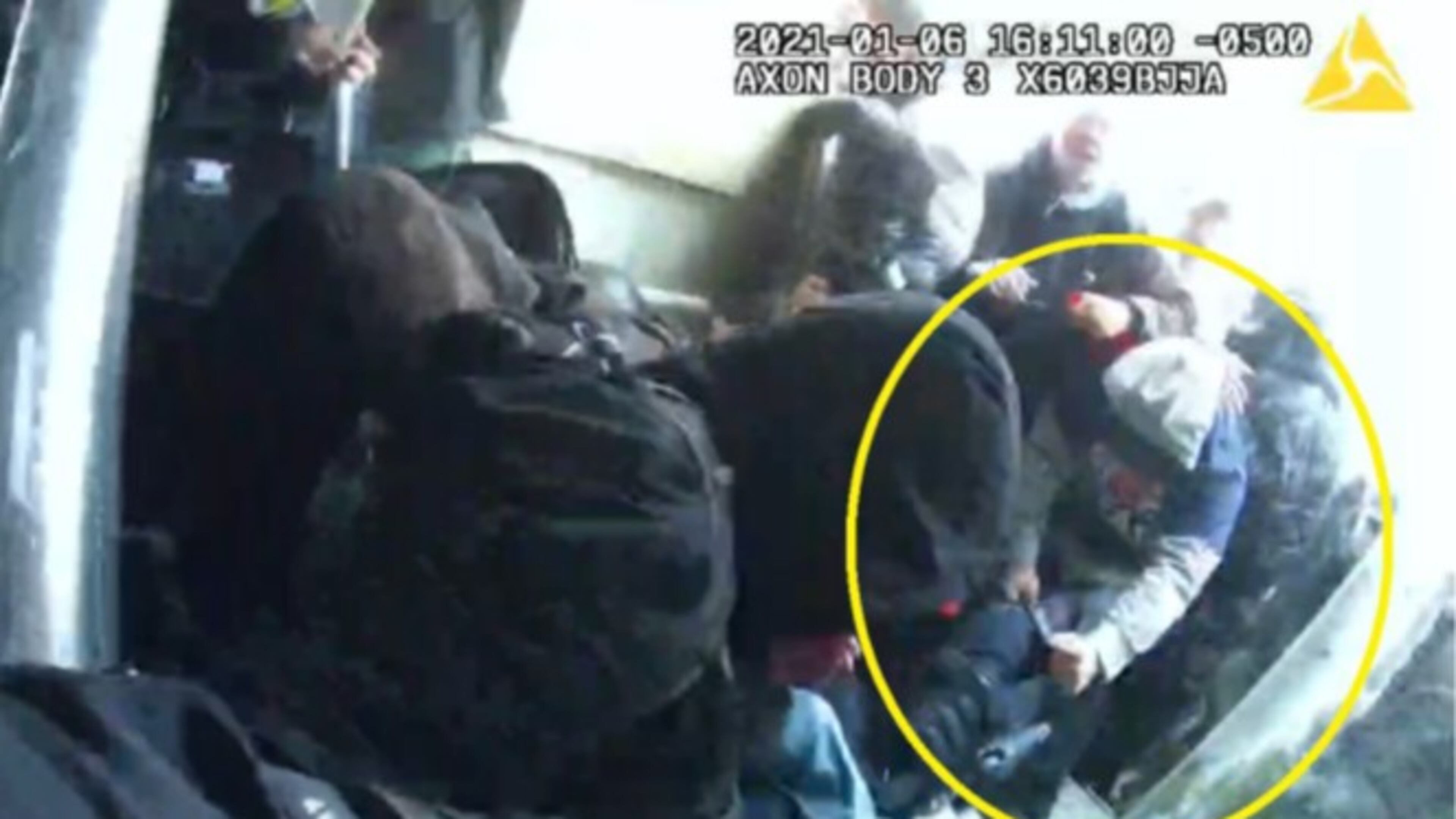 In a still photo captured from police body cameras, a man investigators say is Douglas County resident Phillip Marion "Bunky" Crawford Jr. is seen grabbing a fallen police officer during fighting on Jan. 6, 2021, at the U.S. Capitol.