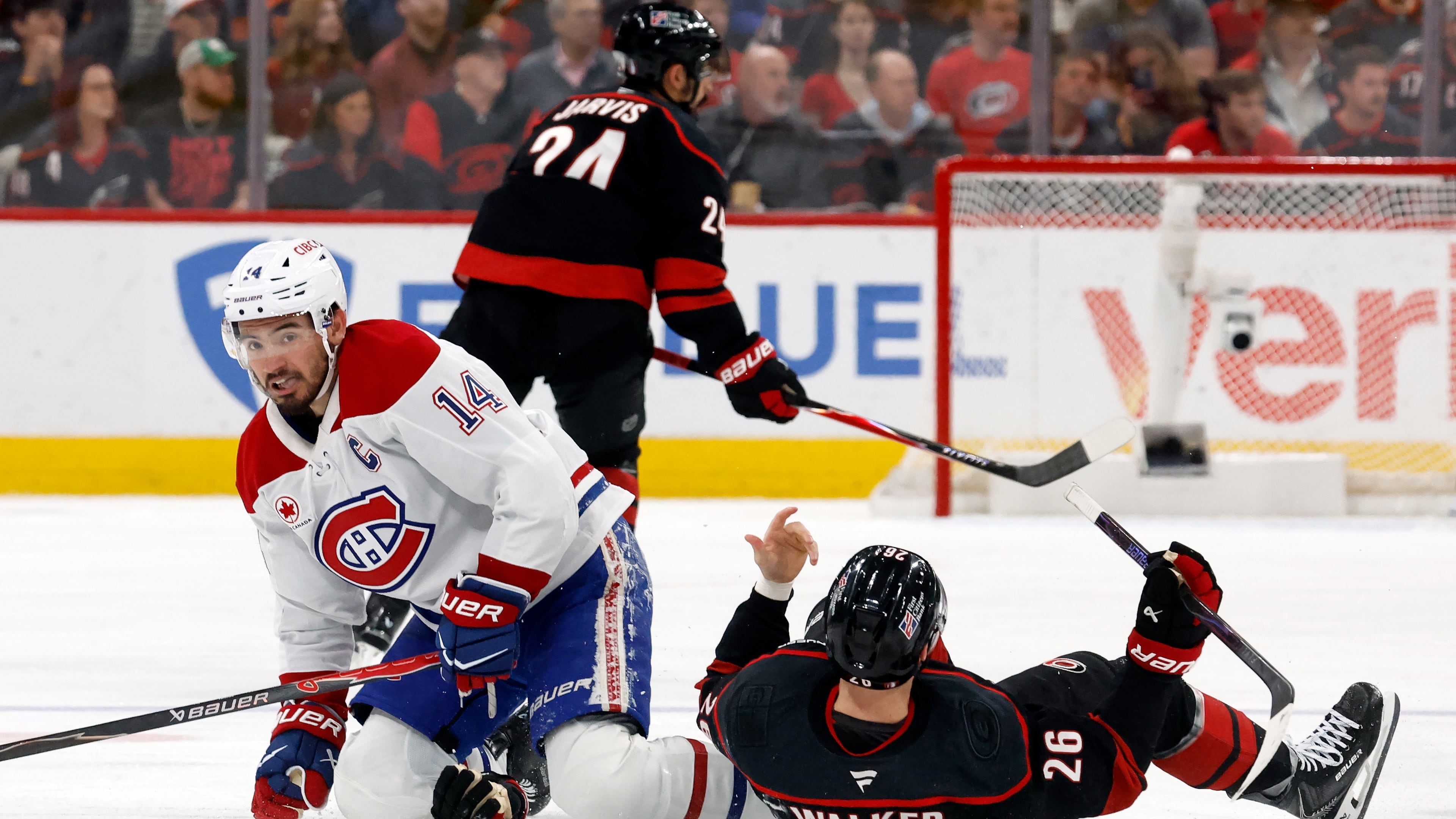 Montréal Canadiens' Nick Suzuki (14) collides with Carolina Hurricanes' Seth Jarvis (24) resulting in both getting penalties during the first period in Game 1 of the Eastern Conference finals NHL hockey Stanley Cup playoffs series in Raleigh, N.C., Thursday, May 21, 2026. (AP Photo/Karl DeBlaker)