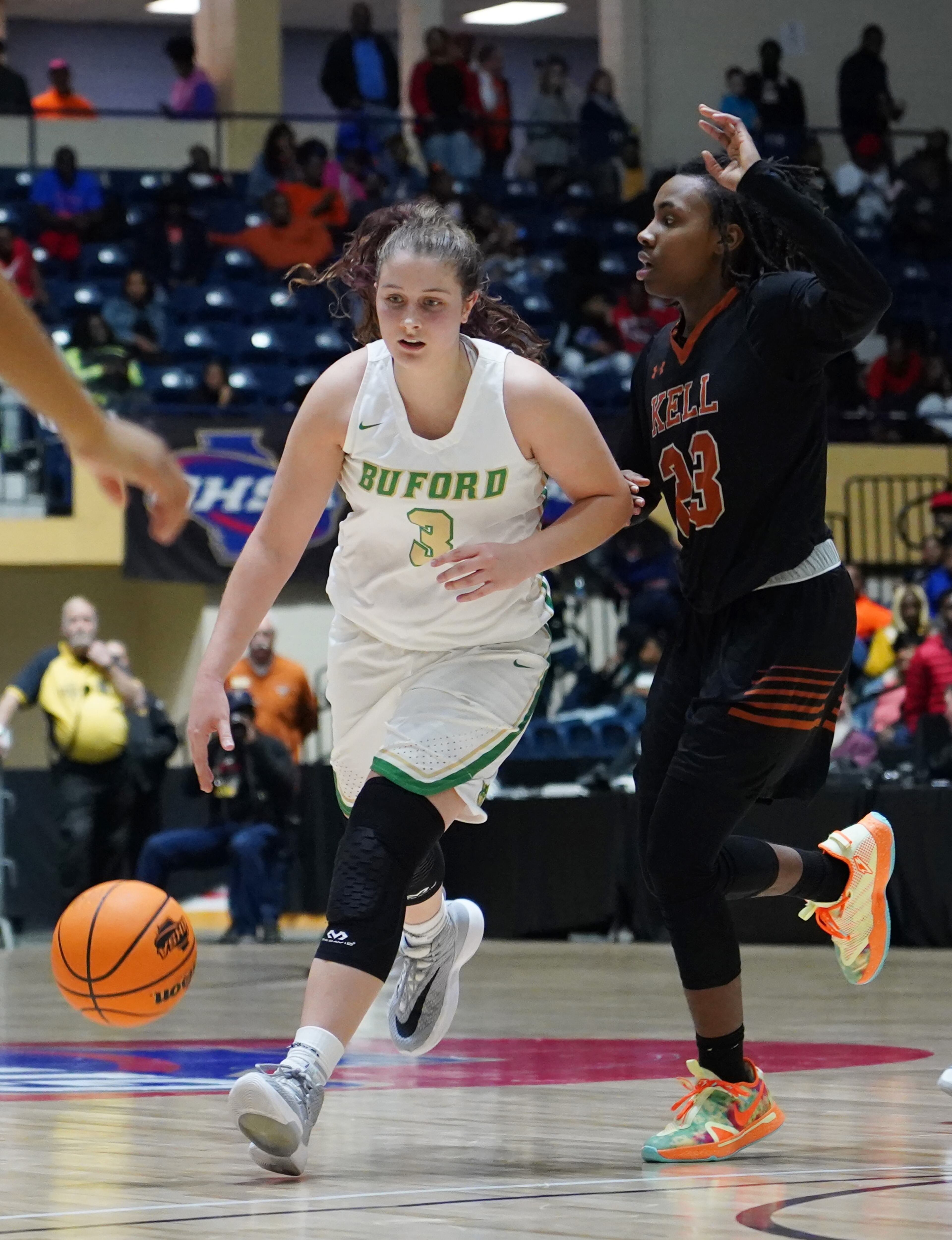 Buford's Tate Walters drives past Kell's Jamiah Gregory in the Class AAAA girls title basketball game at the Macon Centreplex, Friday March 6, 2020, in Macon. Tami Chappell for the Atlanta Journal Constitution