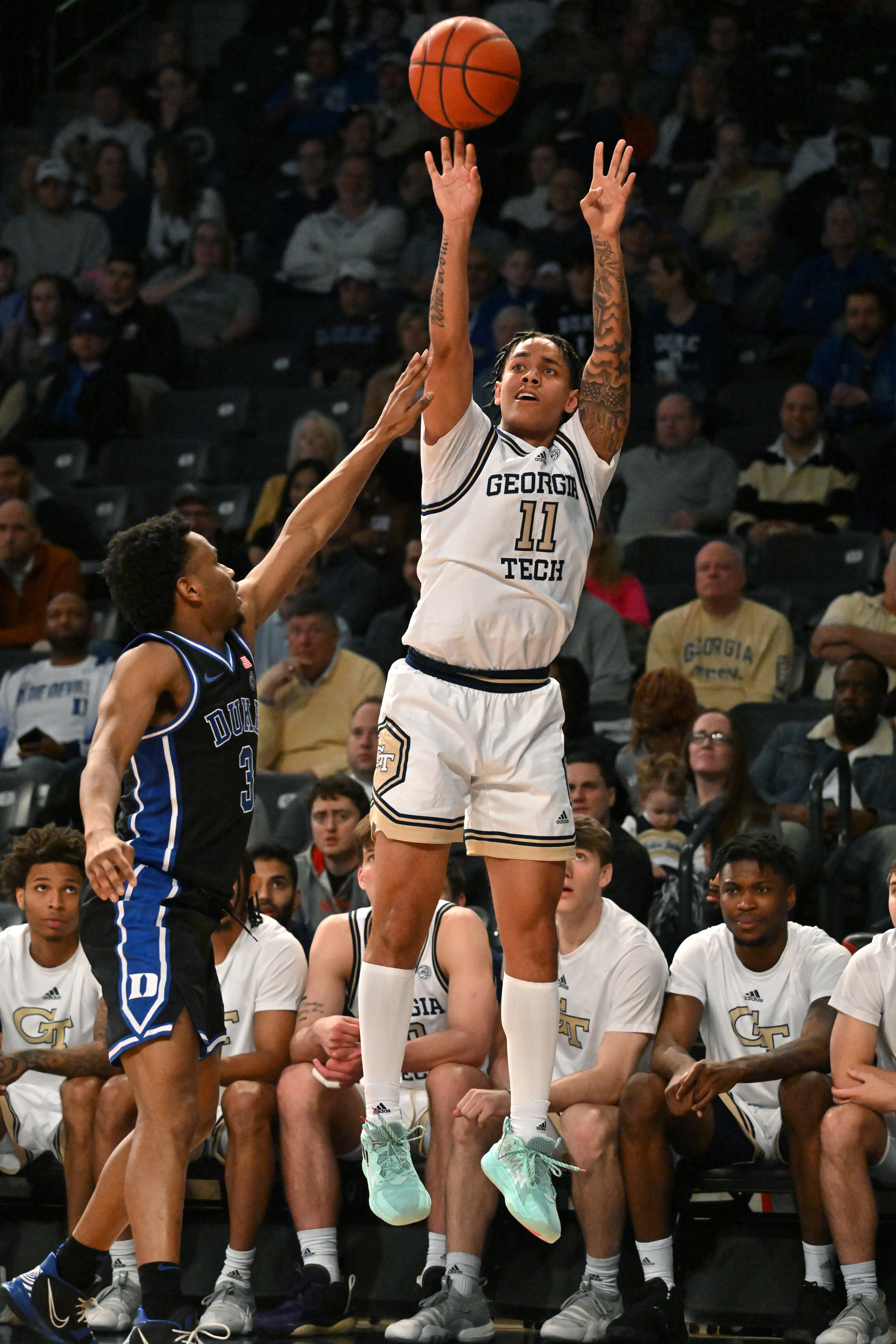 Georgia Tech's guard Tristan Maxwell (11) shoots over Duke’s guard Jeremy Roach (3) during the second half. (Hyosub Shin / Hyosub.Shin@ajc.com)