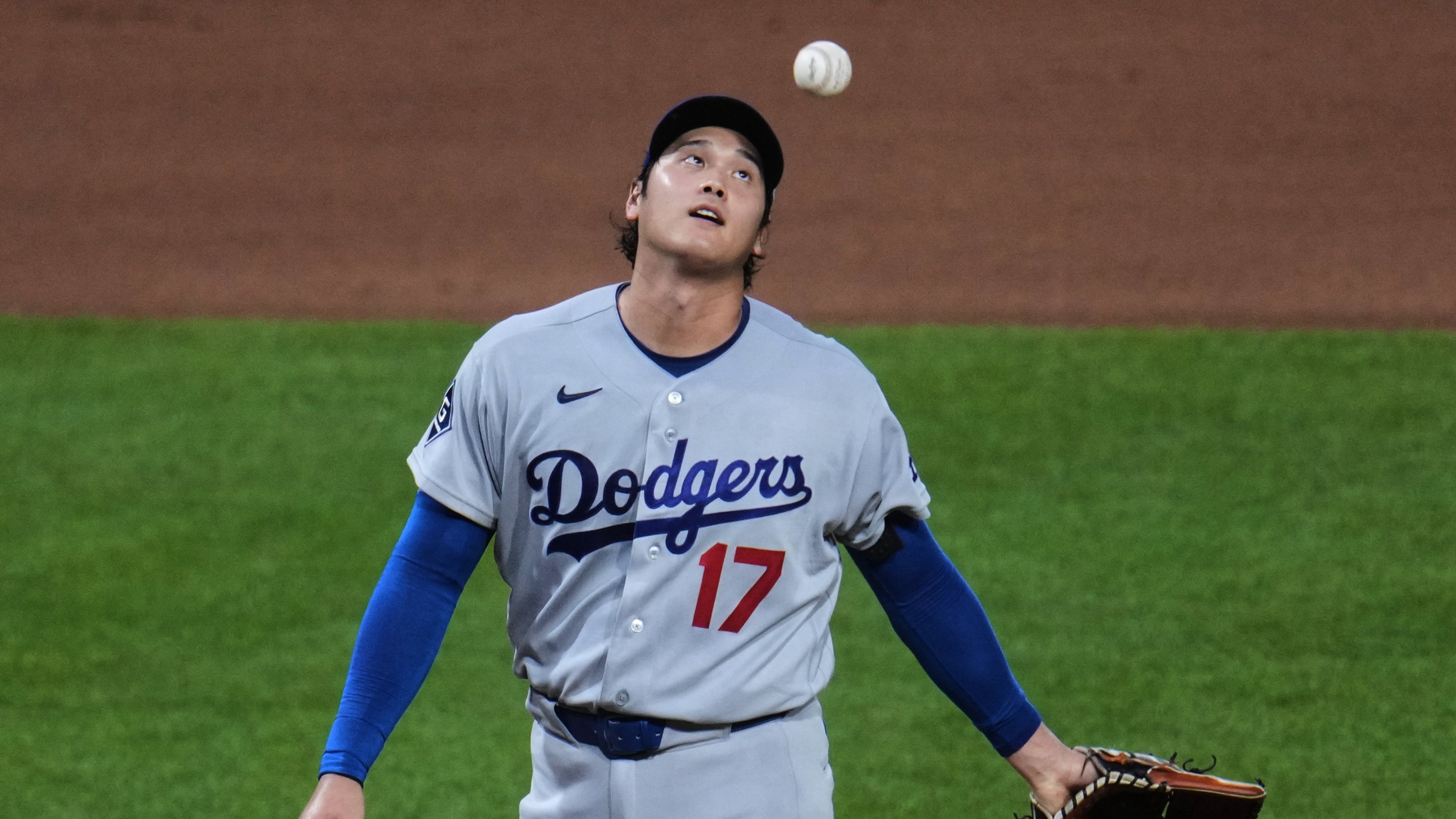 Los Angeles Dodgers two-way player Shohei Ohtani waits to hand the ball to manager Dave Roberts, after giving up a two-run double to Pittsburgh Pirates' Brandon Lowe during the seventh inning of a baseball game in Pittsburgh, Wednesday, June 10, 2026. (AP Photo/Gene J. Puskar)