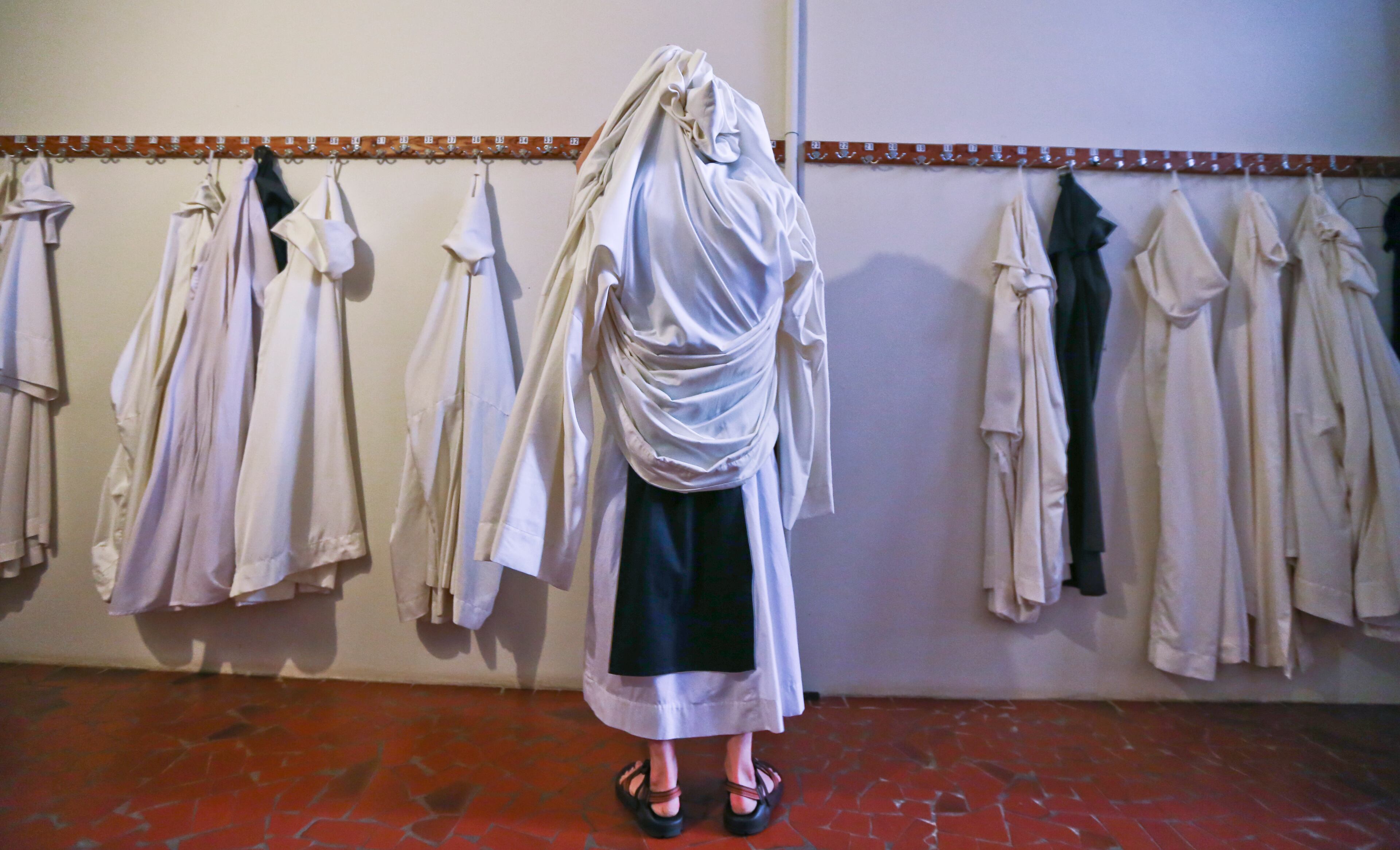 During winter months the monks wear cowls during their prayer offices and liturgies. Here a monk gets ready to hang up his cowl on Thursday November 20, 2014. The Monastery of the Holy Spirit in Conyers has 2,200 acres of beautifully planted gardens and grounds, a visitor's center, museum, cafe, lodging for weekend guests, a gothic abbey church, and a gift shop featuring baked goods, fruitcakes, biscotti and fudge, plus bonsai trees cultivated by the monks. It's an unusual feature of the Conyers landscape that has become an attraction for visitors from across the southeast, for those seeking a spiritual retreat and those just seeking a nice outing. For gift-givers it is also a popular holiday destination. The order of Cistercians of the Strict Observance (OCSO), commonly called the Trappists were founded in the 11th century and follow the rule of St. Benedict in their Christian monastic practice. JOHN SPINK/JSPINK@AJC.COM