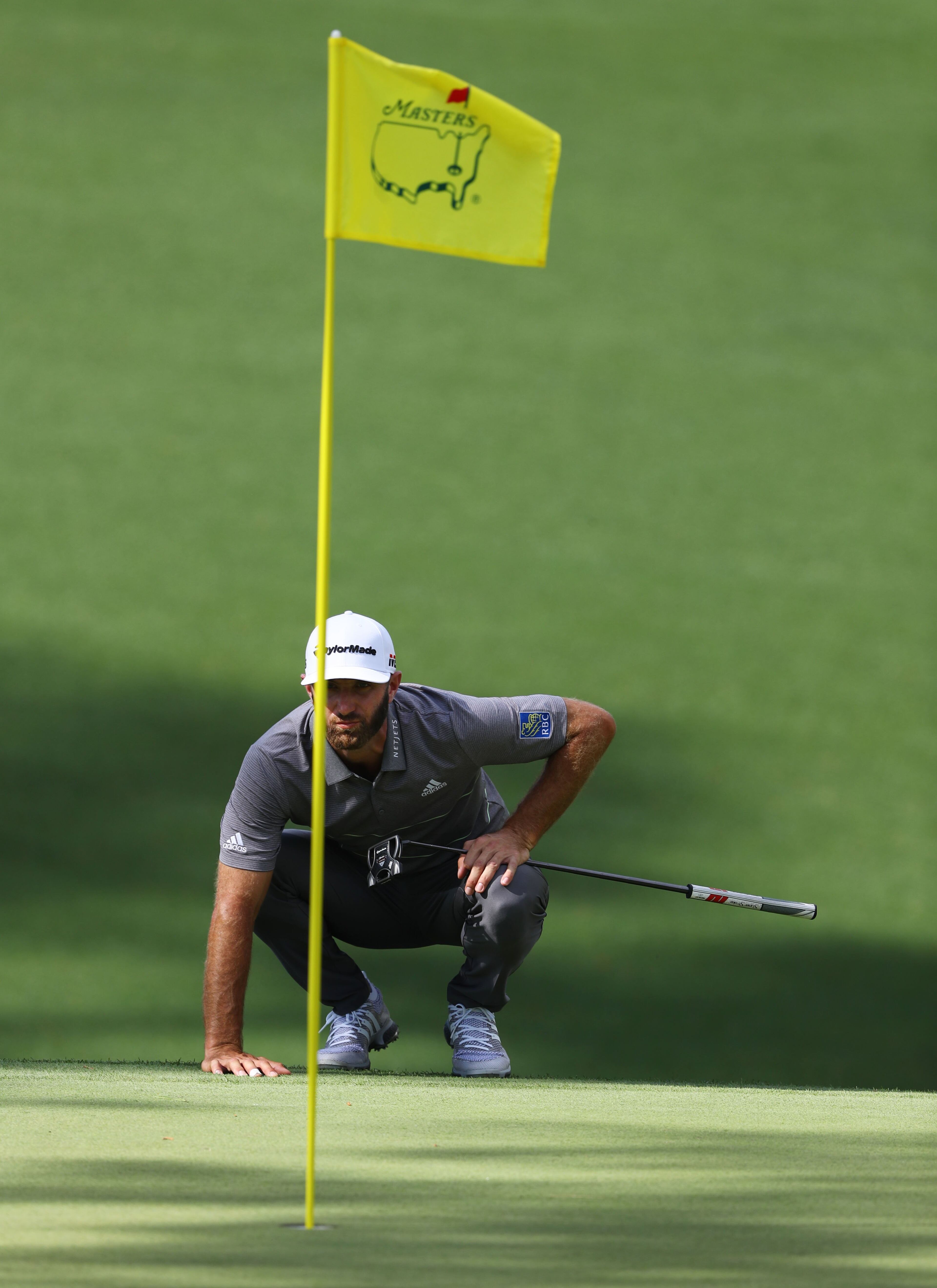 April 11, 2019 - Augusta - Dustin Johnson lines up his putt on 10 during the first round of the Masters Tournament Thursday, April 11, 2019, at Augusta National Golf Club in Augusta. Curtis Compton / ccompton@ajc.com