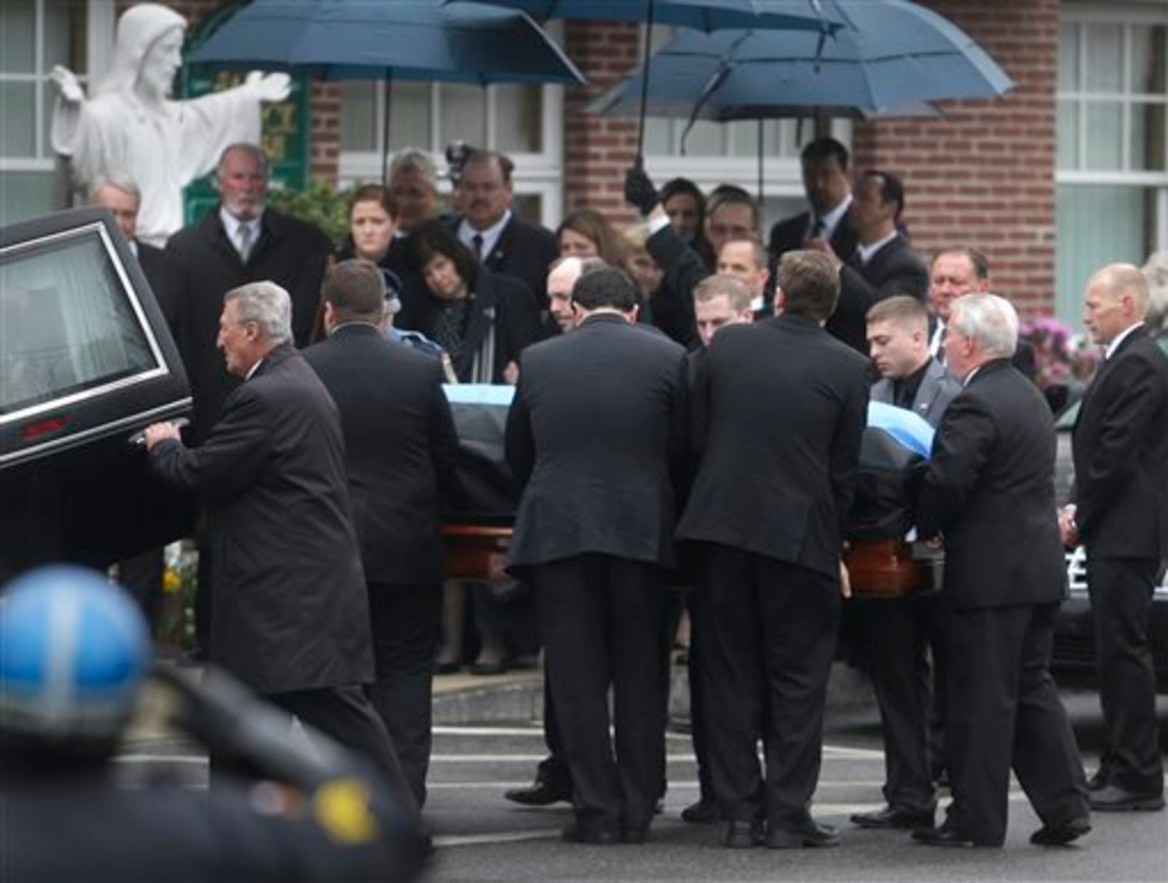 Pallbearers carry the casket of fallen Massachusetts Institute of Technology police officer Sean Collier into St. Patrick's Church before a funeral Mass, in Stoneham, Mass., Tuesday, April 23, 2013. Collier was fatally shot on the MIT campus Thursday, April 18, 2013. Authorities allege that the Boston Marathon bombing suspects were responsible. (AP Photo/Steven Senne)