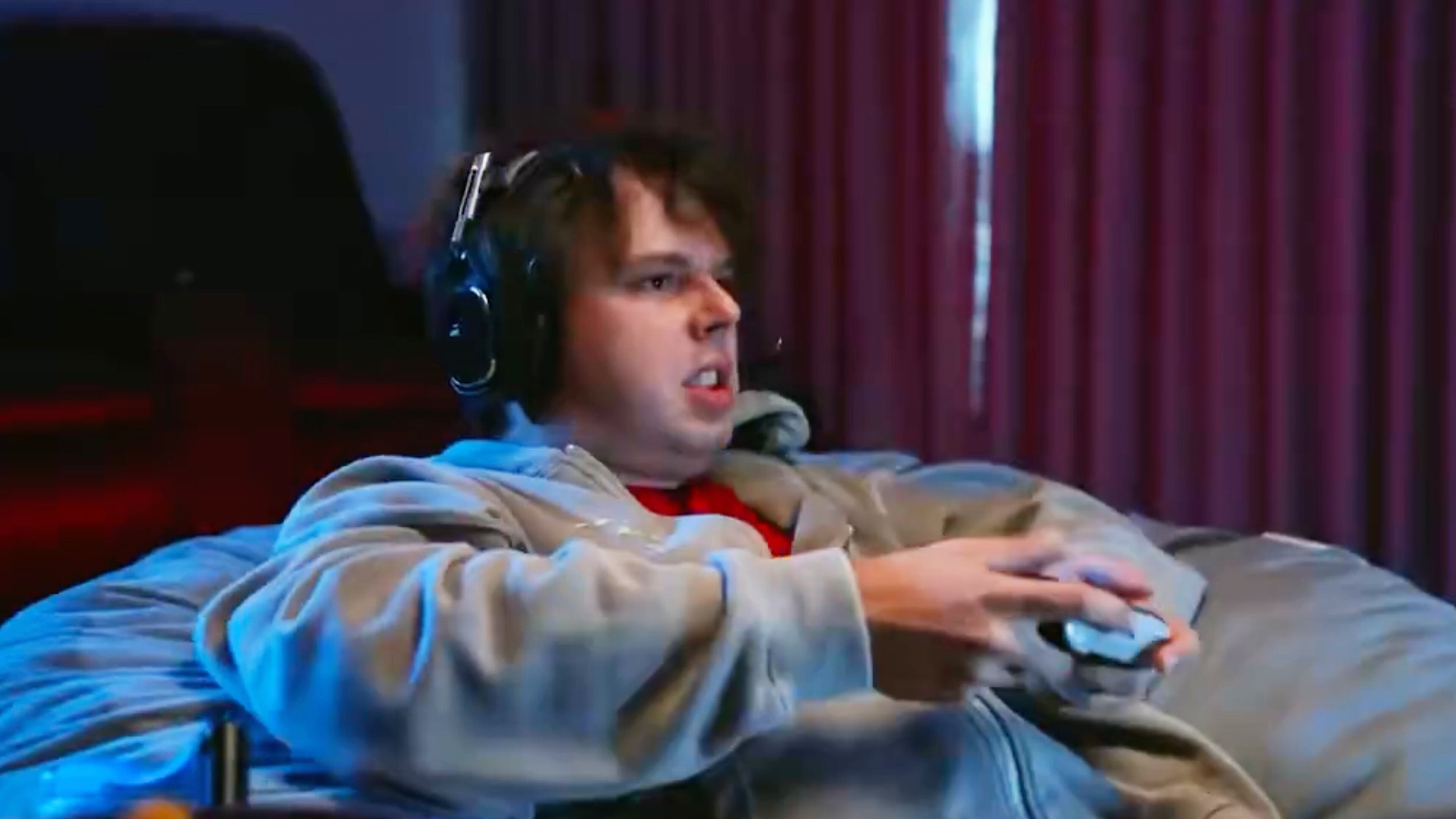 This image from a video released by the Sarah Huckabee Sanders campaign on Monday, Sept. 28, 2026, shows an actor portraying a unemployed young man playing a video game. (Sarah Huckabee Sanders via AP)