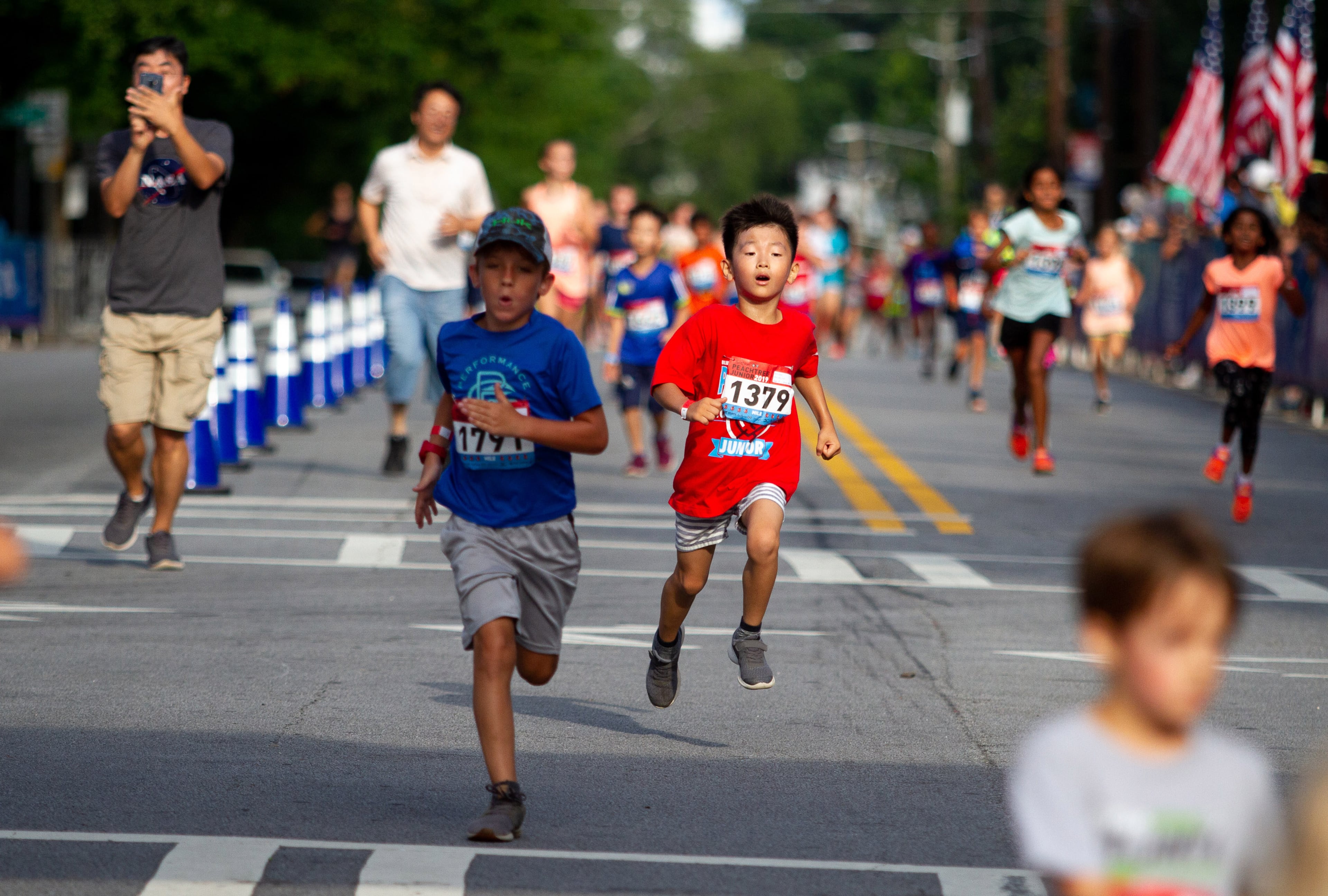 Runners sprint for the finish line during The Anthem Peachtree Junior race on 10th Street Wednesday, July 3, 2019. STEVE SCHAEFER / SPECIAL TO THE AJC