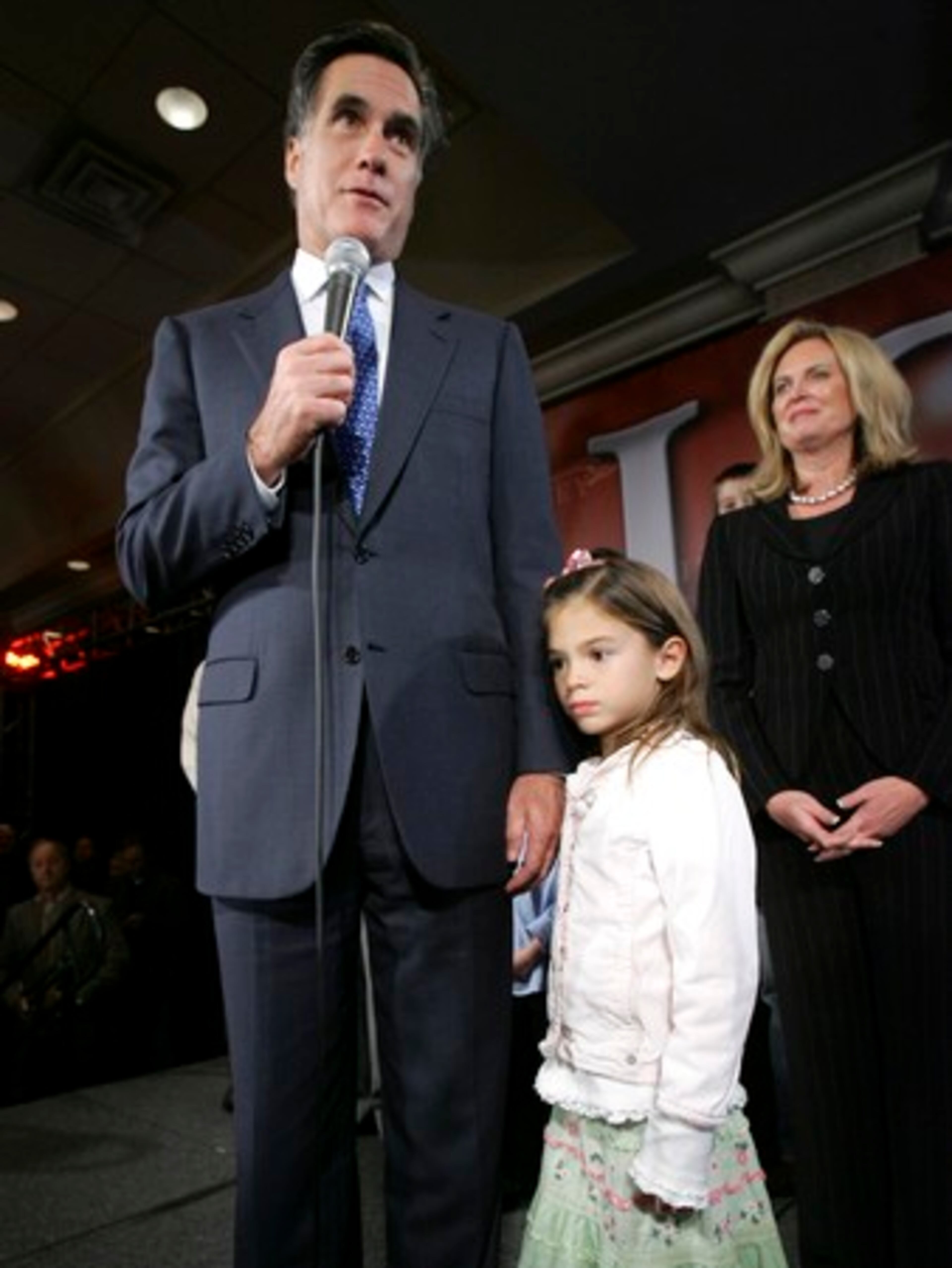 With his grand daughter Chloe Romney, 7, holding his hand, Republican presidential hopeful former Massachusetts Gov. Mitt Romney, left, speaks to supporters with his wife Ann Romney in Bedford, N.H., Tuesday, Jan. 8, 2008. Romney pledged a long fight for the Republican presidential nomination on, despite finishing second to John McCain in the New Hampshire primary.