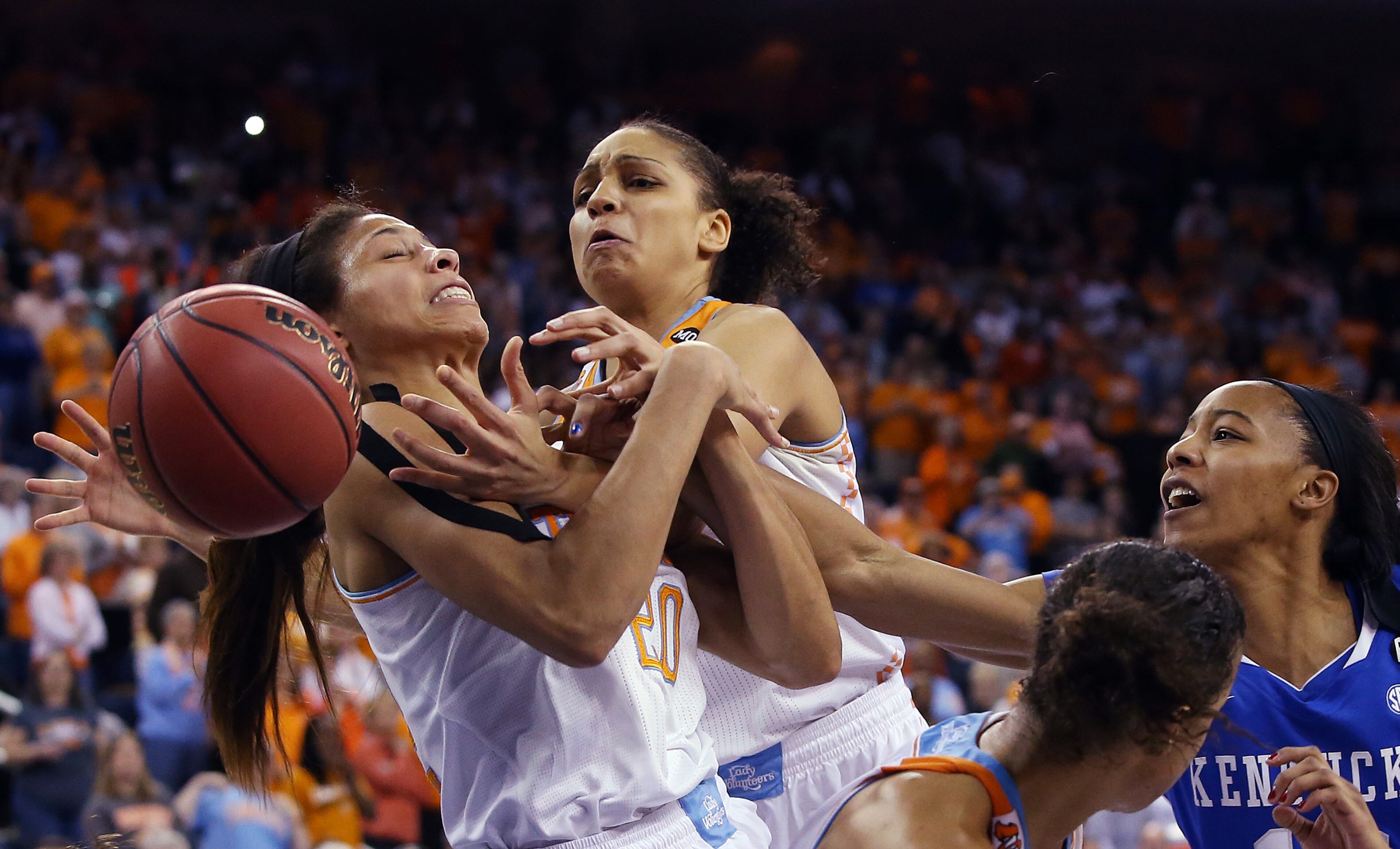 Tennessee center Isabelle Harrison (20), left, and Tennessee forward Bashaara Graves battle Kentucky forward/center Jelleah Sidney, right, for a rebound in the second half of an NCAA college basketball game in the finals of the Southeastern Conference women's basketball tournament Sunday, March 9, 2014, in Duluth, Ga. Tennessee won 71-70. (AP Photo/Jason Getz)