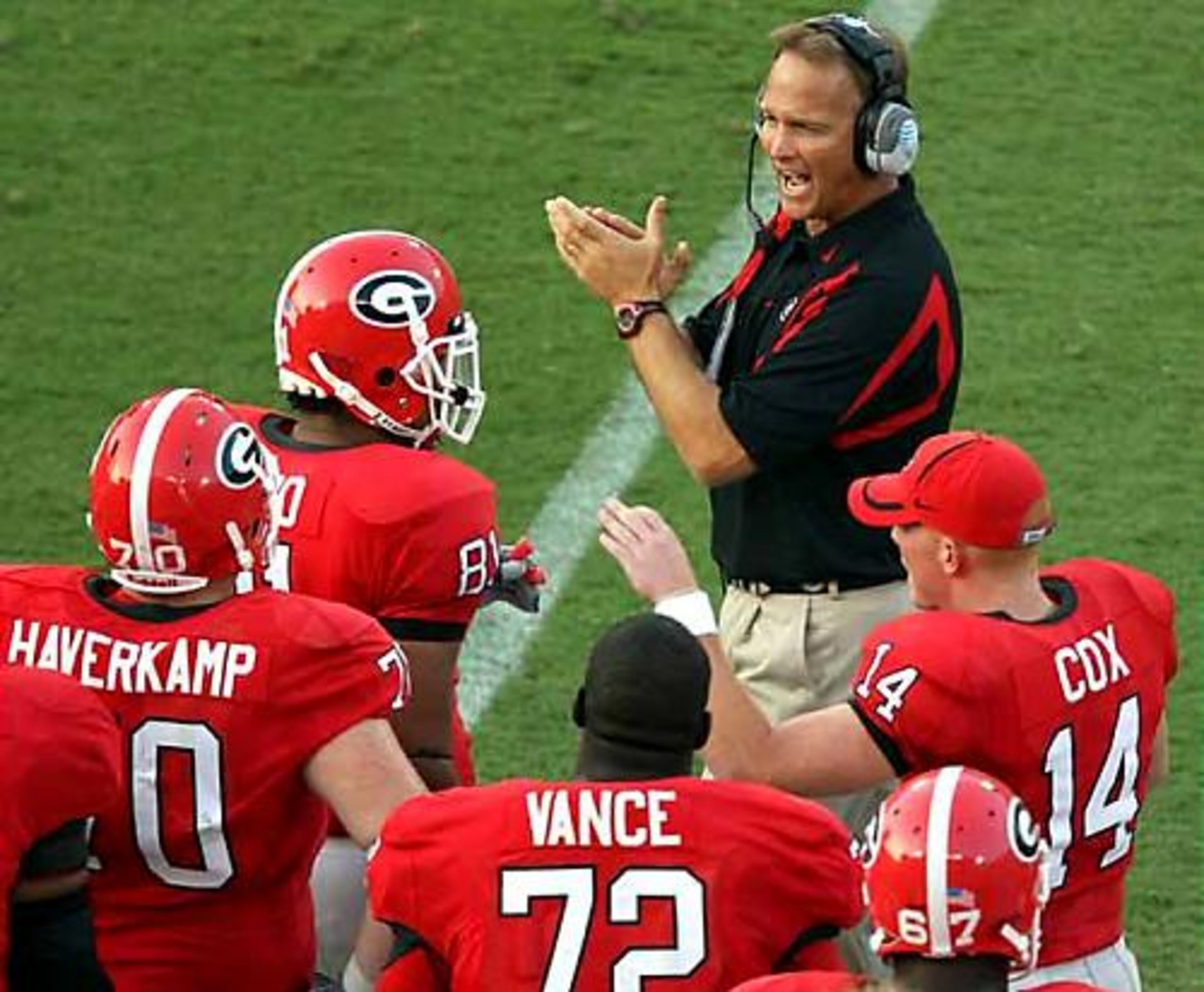 Freed from calling plays, coach Mark Richt cheers on his team in the first quarter of the UGA vs. Oklahoma State home opener at Sanford Stadium.