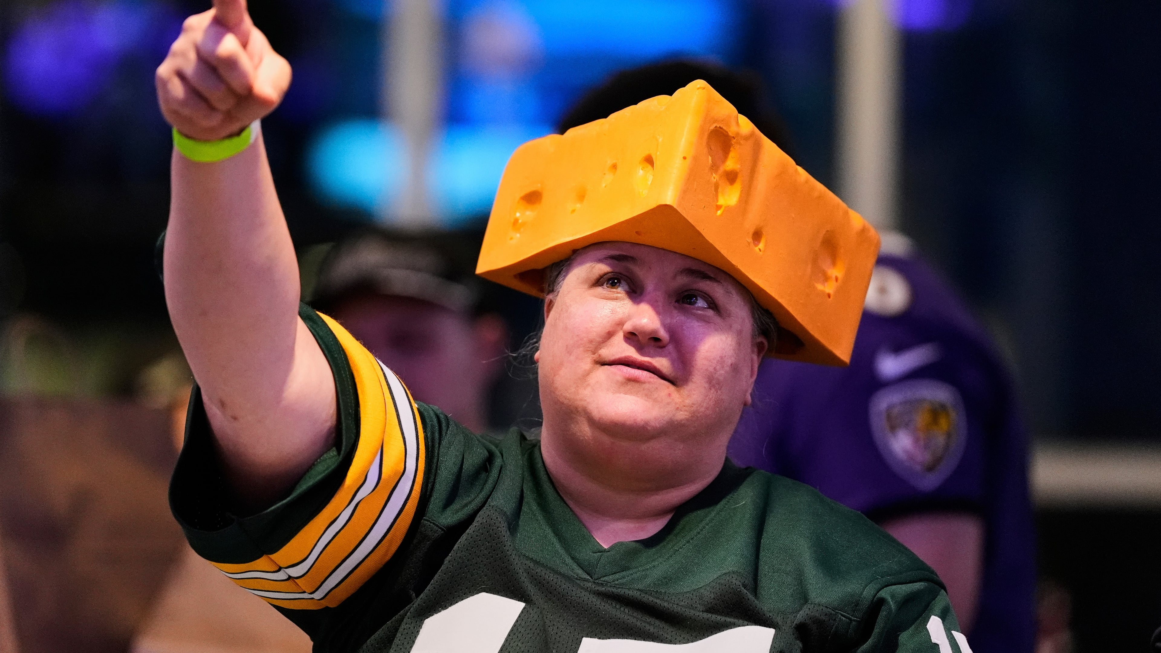 FILE - A Green Bay Packers fan wears a cheesehead hat during a Ravens football draft party at M&T Bank Stadium in Baltimore, April 24, 2025. (AP Photo/Stephanie Scarbrough, File)