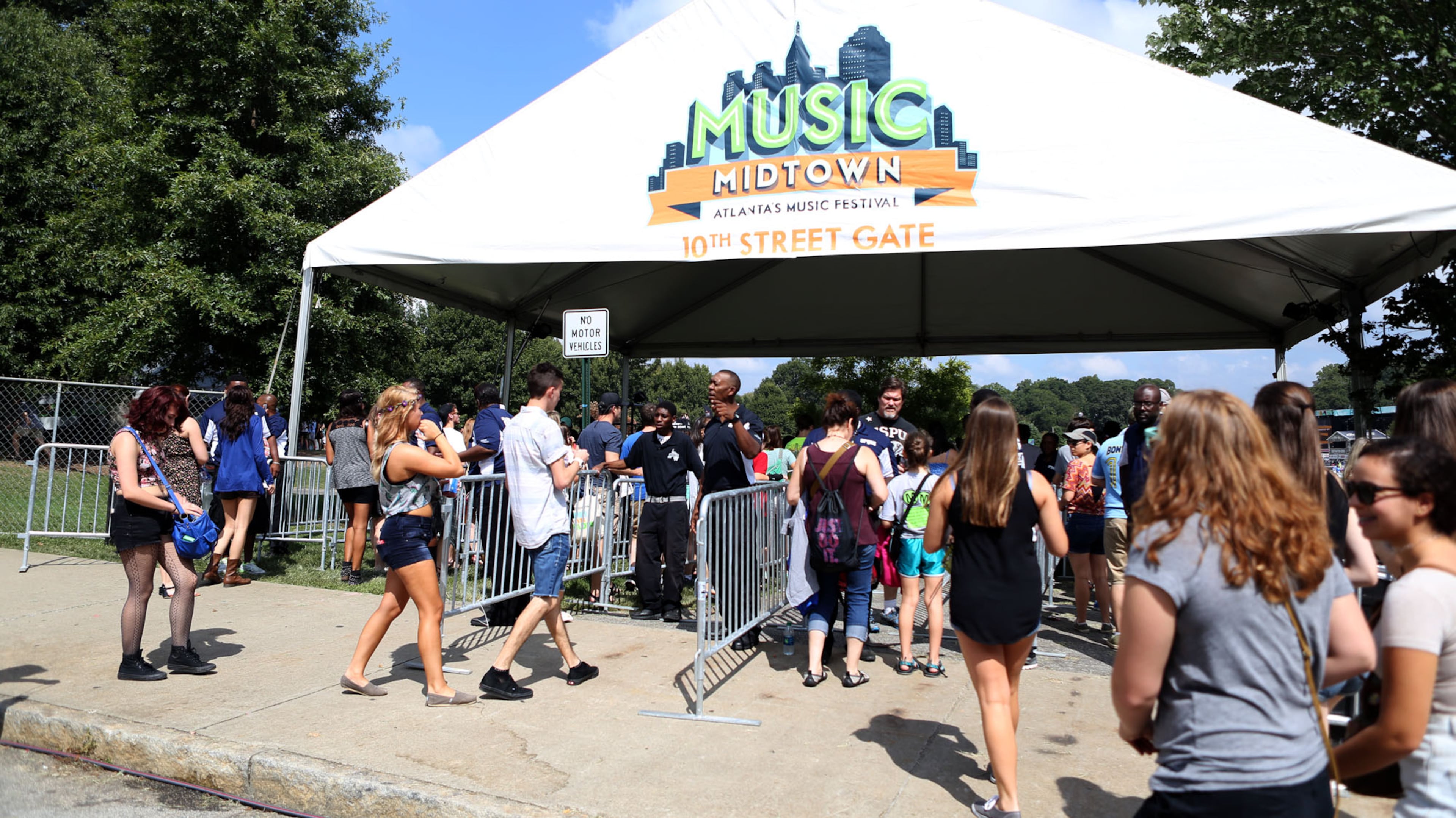 Sept 20, 2014 - ATLANTA - Crowds streaming into the 10th Street gates on Day 2 of Music Midtown at Piedmont Park on Saturday. (Akili-Casundria Ramsess/Special to the AJC)