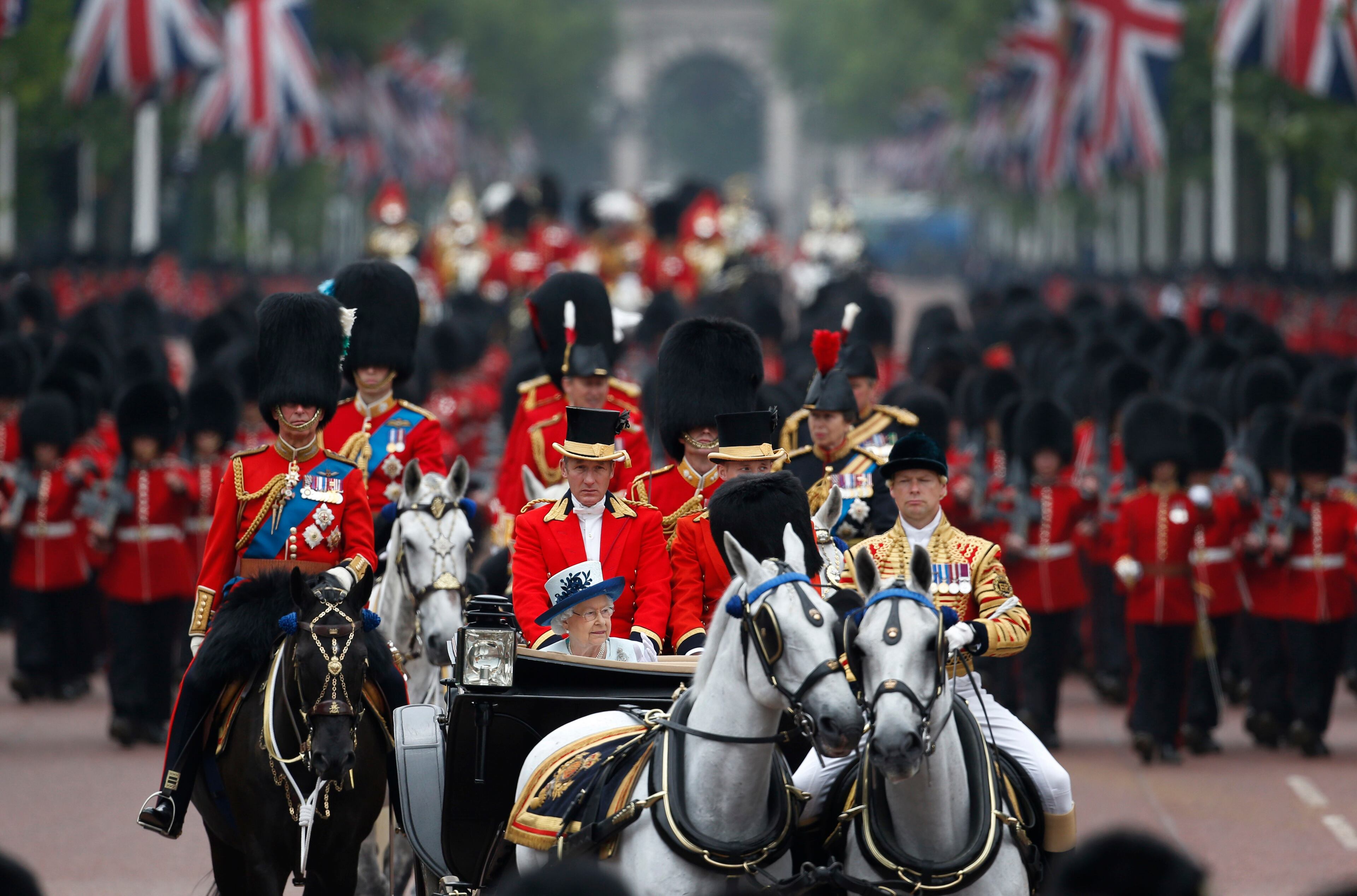 Britain's Queen Elizabeth II returns in a horse-drawn carriage during the Trooping The Colour parade, in central London, Saturday, June 14, 2014. "Trooping the Color" originated from traditional preparations for battle, when flags were carried or "trooped" down the rank for soldiers to see. (AP Photo/Lefteris Pitarakis)