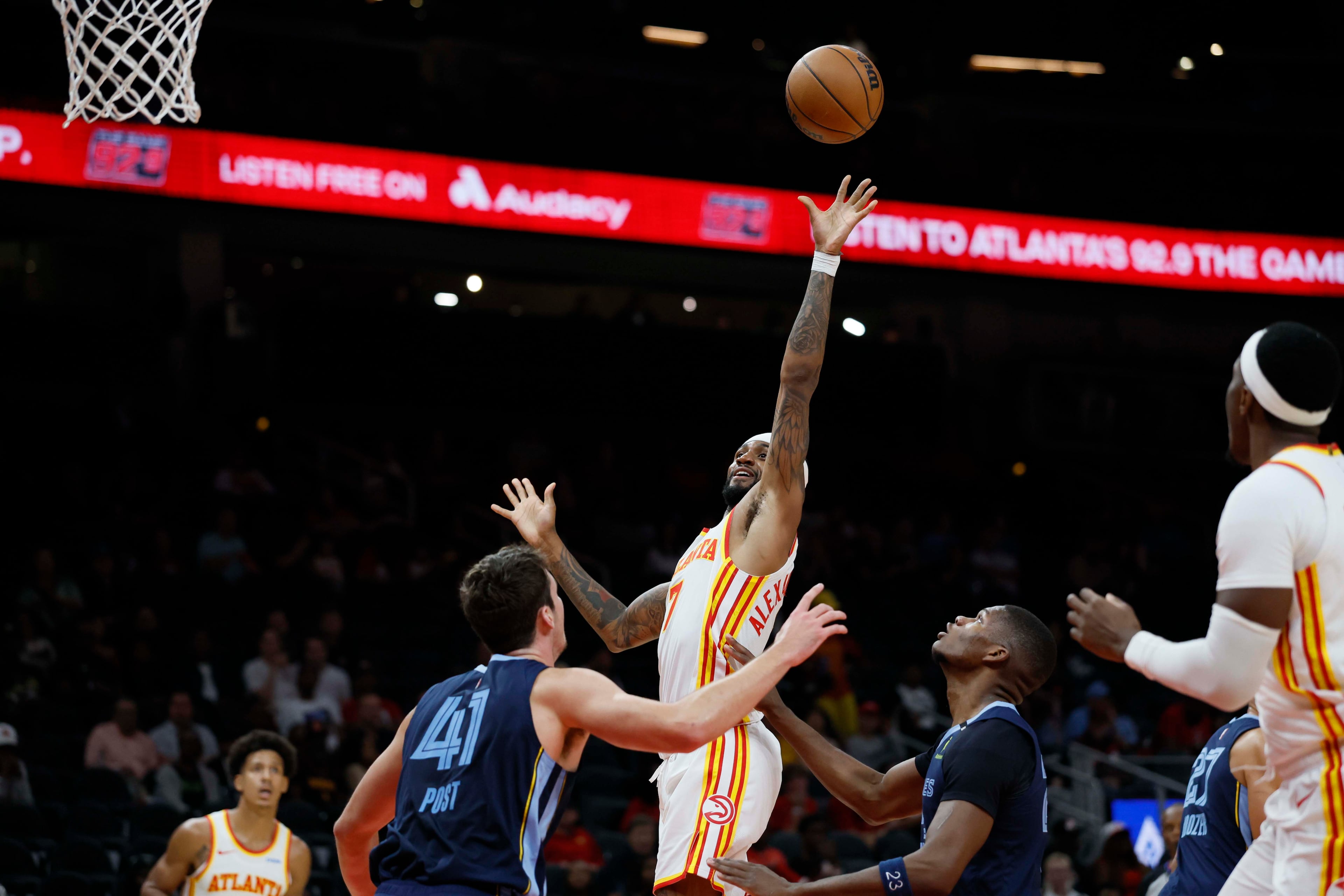 Atlanta Hawks guard Nickeil Alexander-Walker (center) goes up for a basket against Memphis Grizzlies center Quinten Post during the first half of a preseason NBA game at State Farm Arena in Atlanta on Monday, Oct. 5, 2026. (Miguel Martinez/AJC)