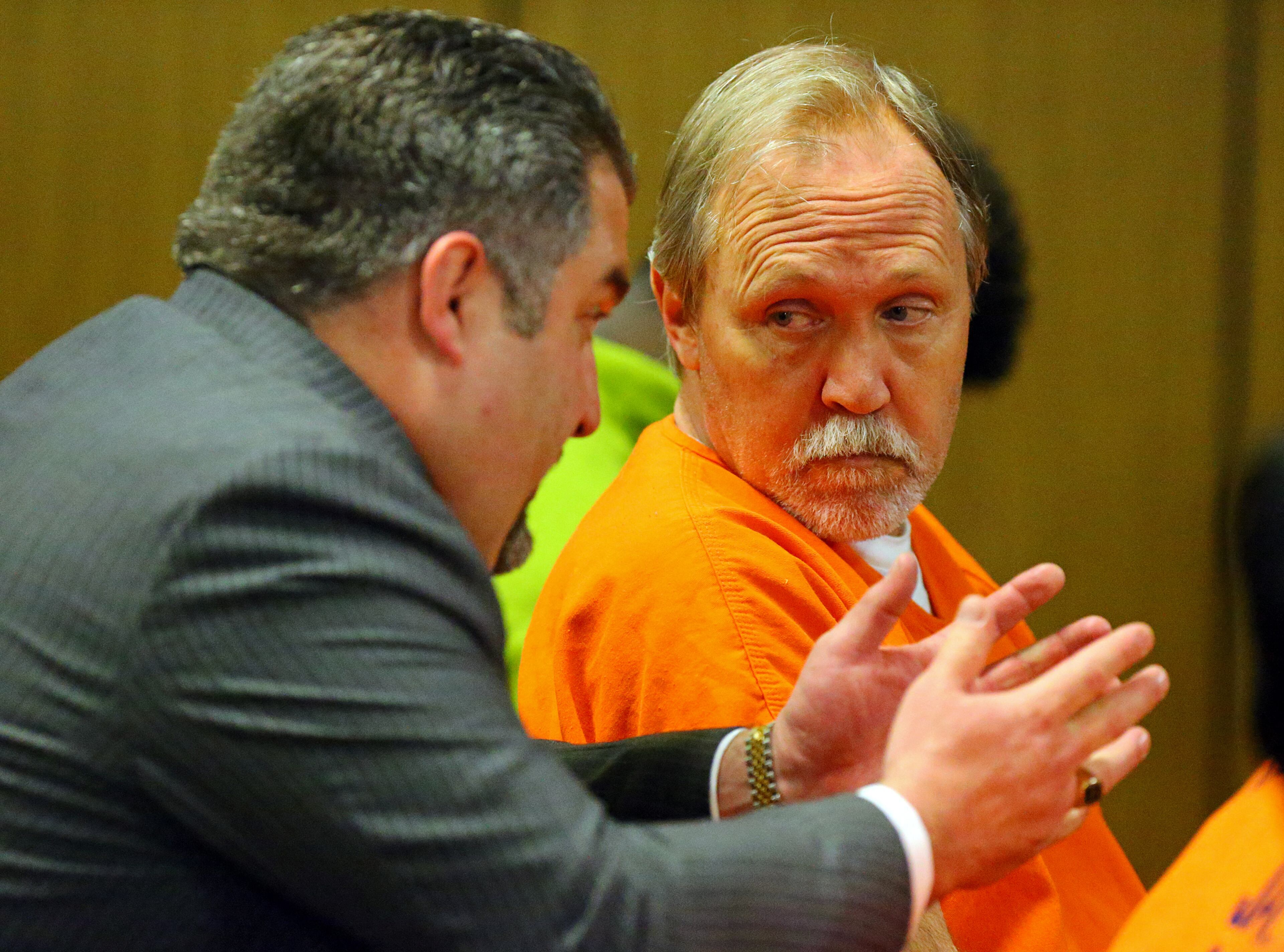 John McGill, principal of Mt. Carmel Elementary School in Douglas County, confers with his attorney Mac Pilgrim during his first appearance hearing at DeKalb County Magistrate Court on Tuesday, March 4, 2014, in Decatur. He is accused of a felony offense of electronic pornography and child exploitation.