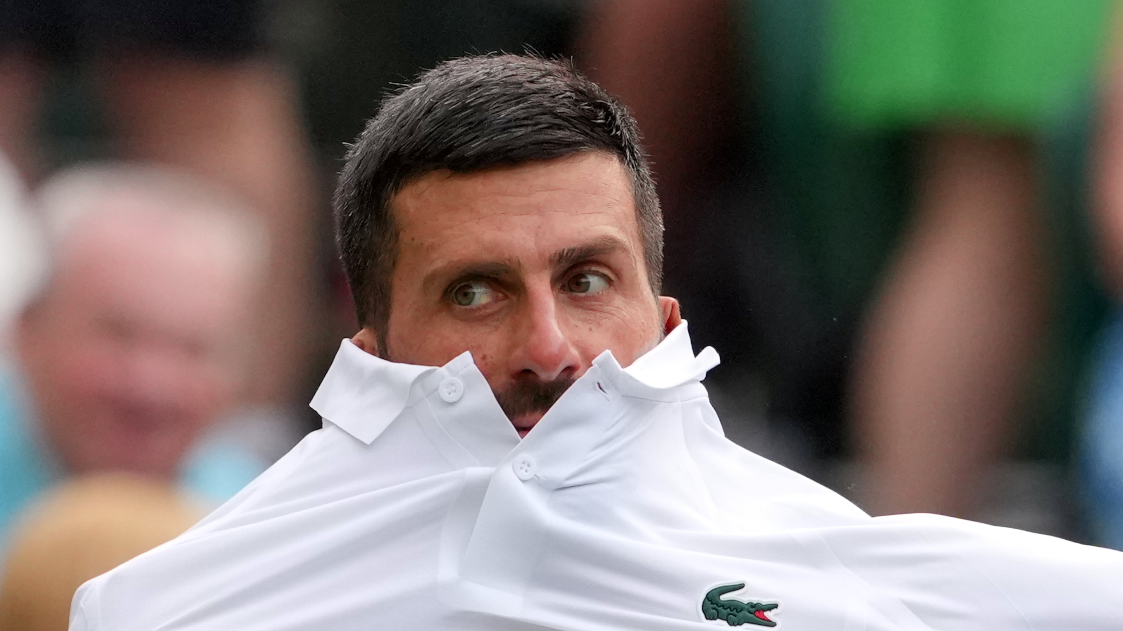 Novak Djokovic of Serbia changes his shirt during the men's singles match against Yibing Wu of China at the Wimbledon Tennis Championships in London, Monday, June 29, 2026.(AP Photo/Kin Cheung)