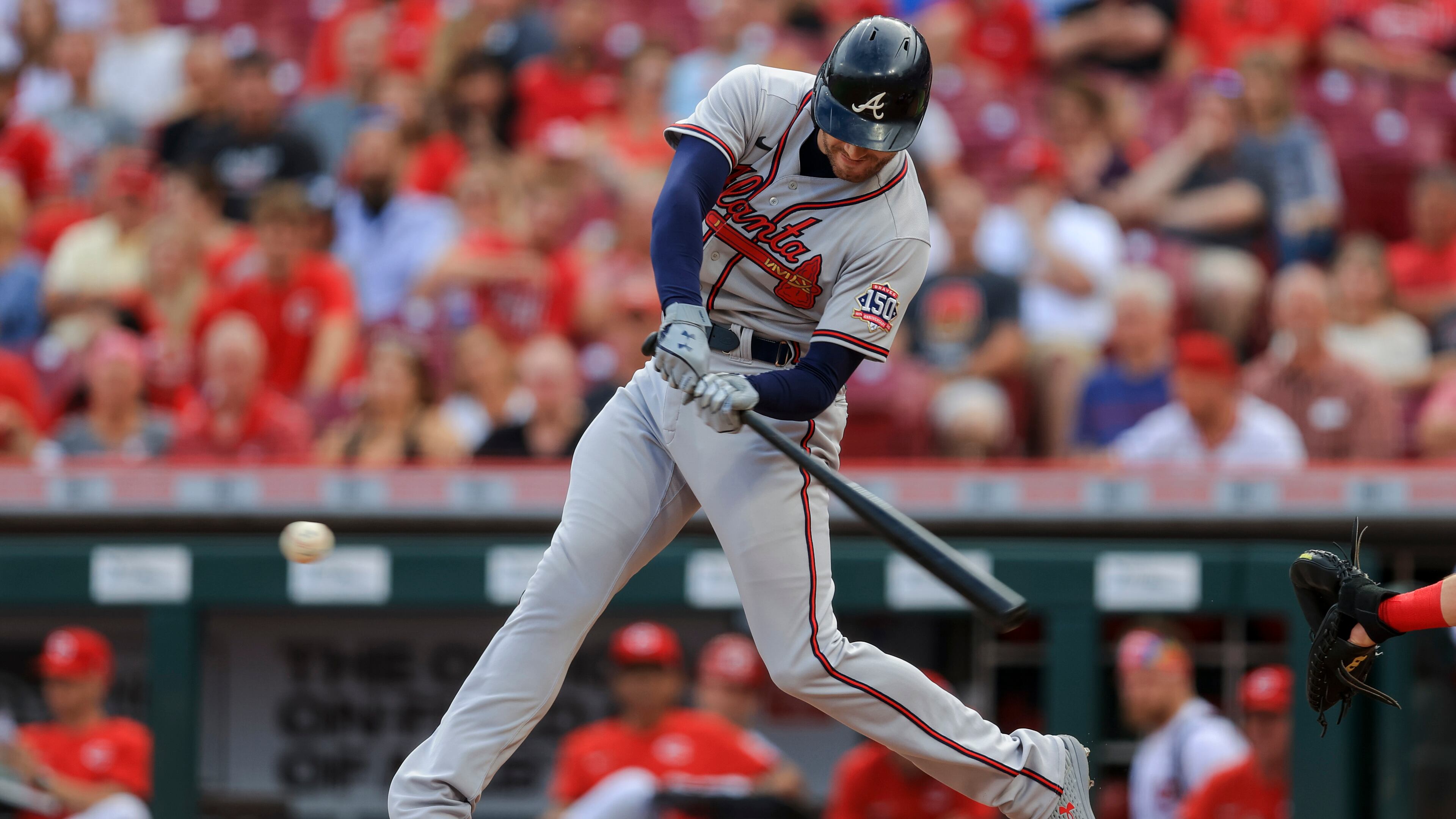 Freddie Freeman follows through on his double in the first inning of Friday's game against the Reds in Cincinnati.