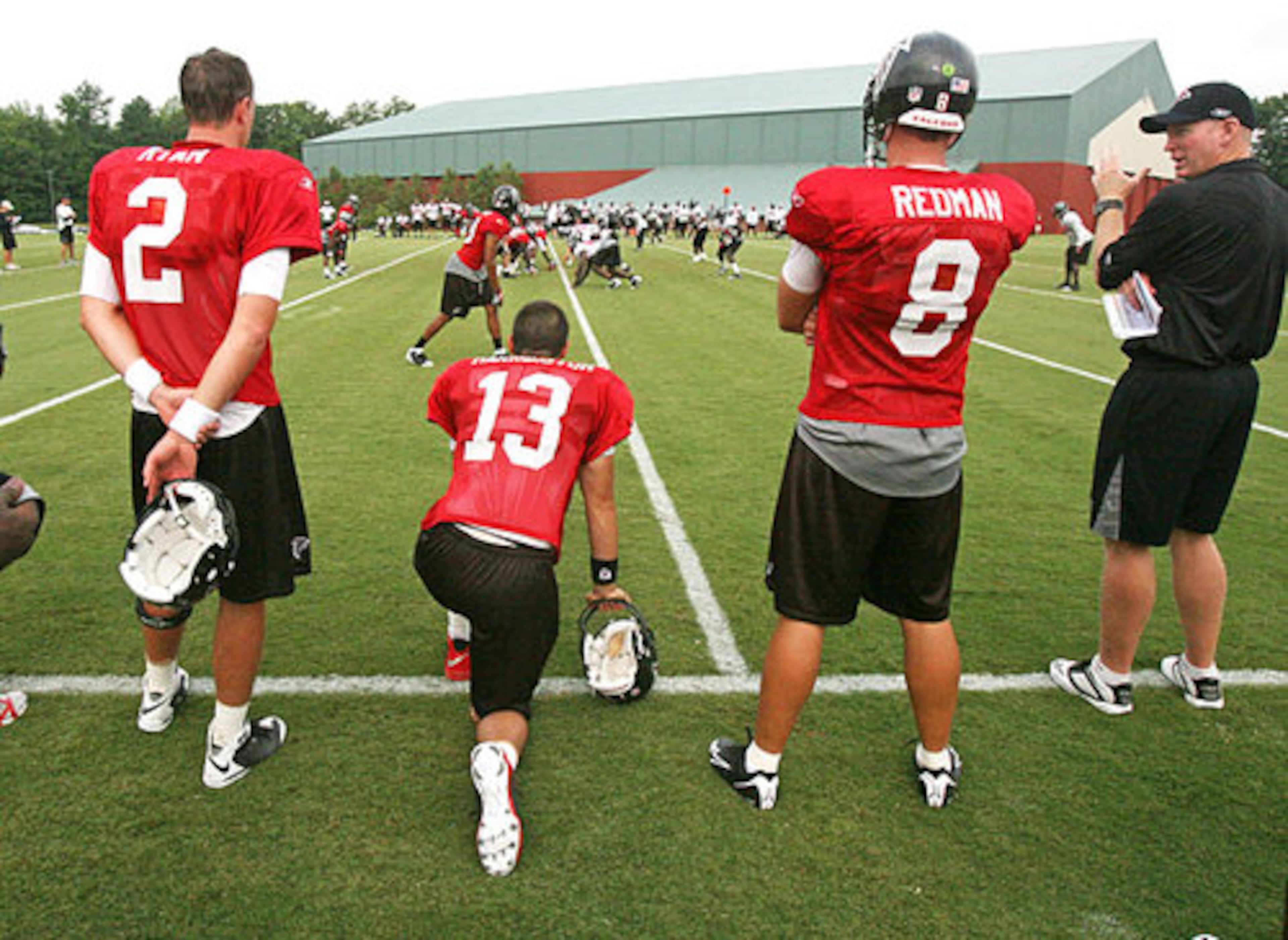 Falcons quarterback Matt Ryan (left) with teammates and then-QB coach Bill Musgrave (right).