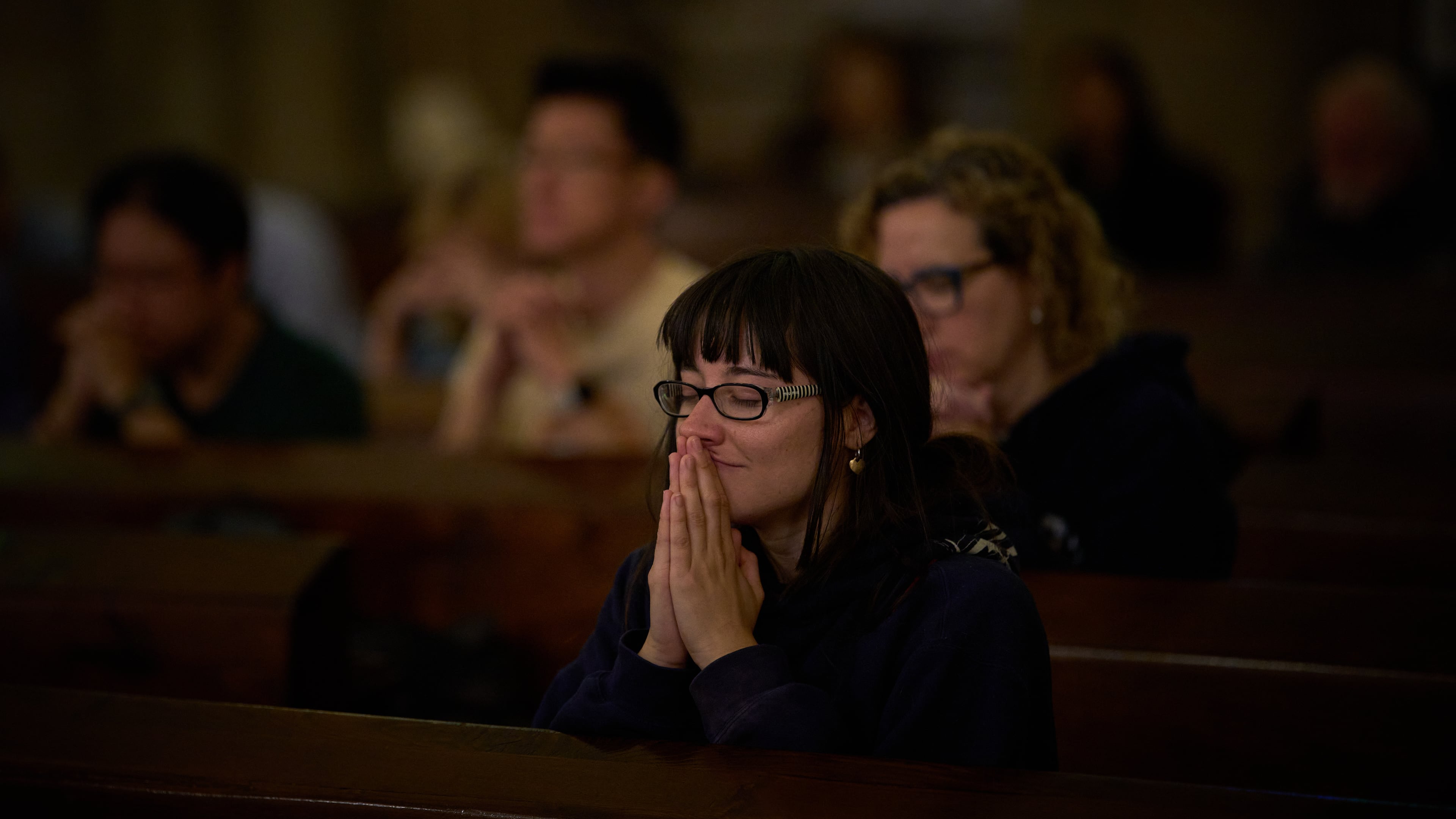 Parishioners pray during a mass in the crypt of the Sagrada Familia in Barcelona, Spain, Friday, May 15, 2026. (AP Photo/Emilio Morenatti)