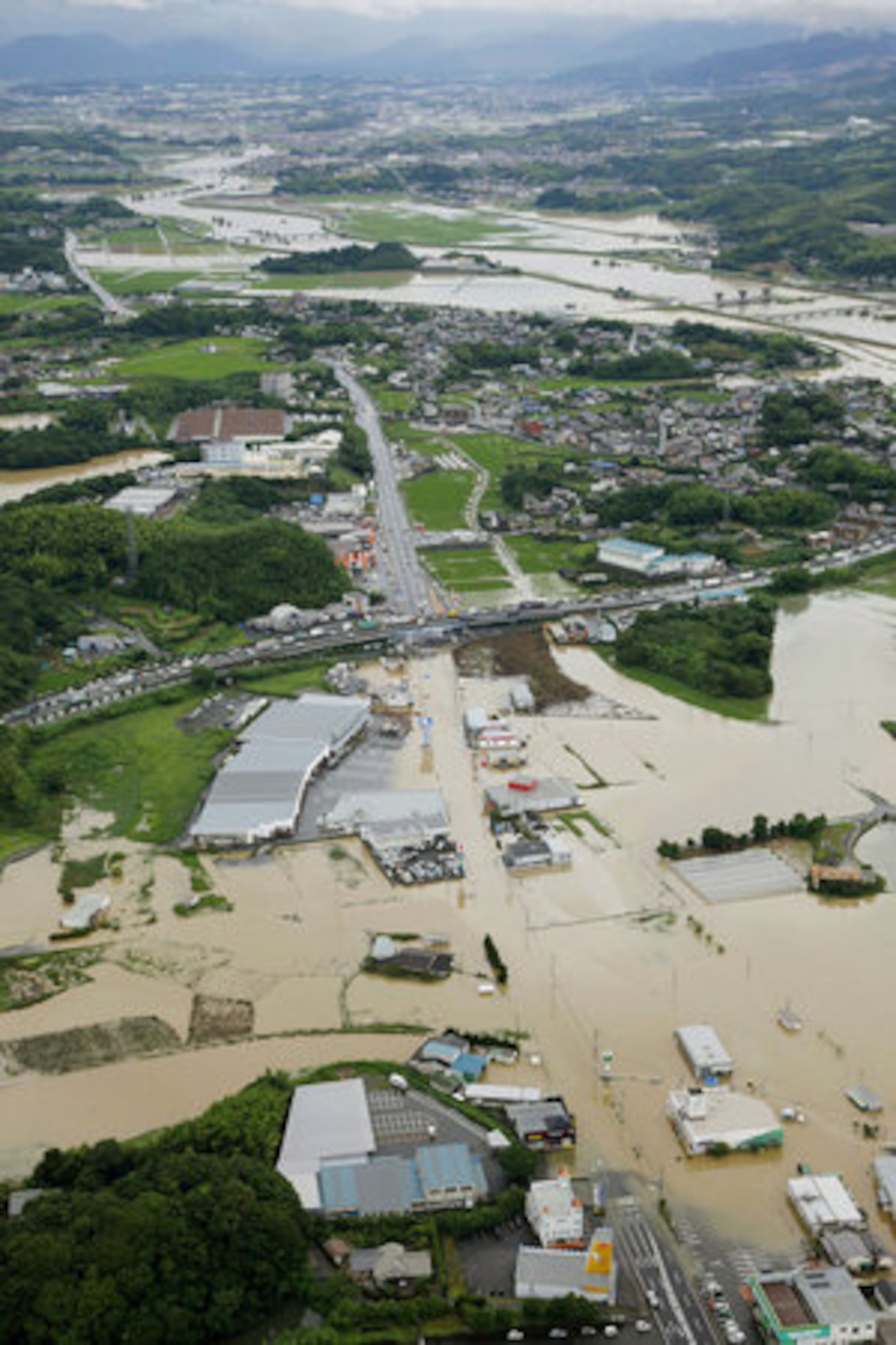 July 13, southern Japan - Houses and farmland were inundated by flood waters in Nogata after storms lashed southern and western Japan, leaving one dead and three missing. A woman drowned in a swollen river, and three people, including two women in their 70s, were missing, according to officials. Nearly 10,000 homes were evacuated.