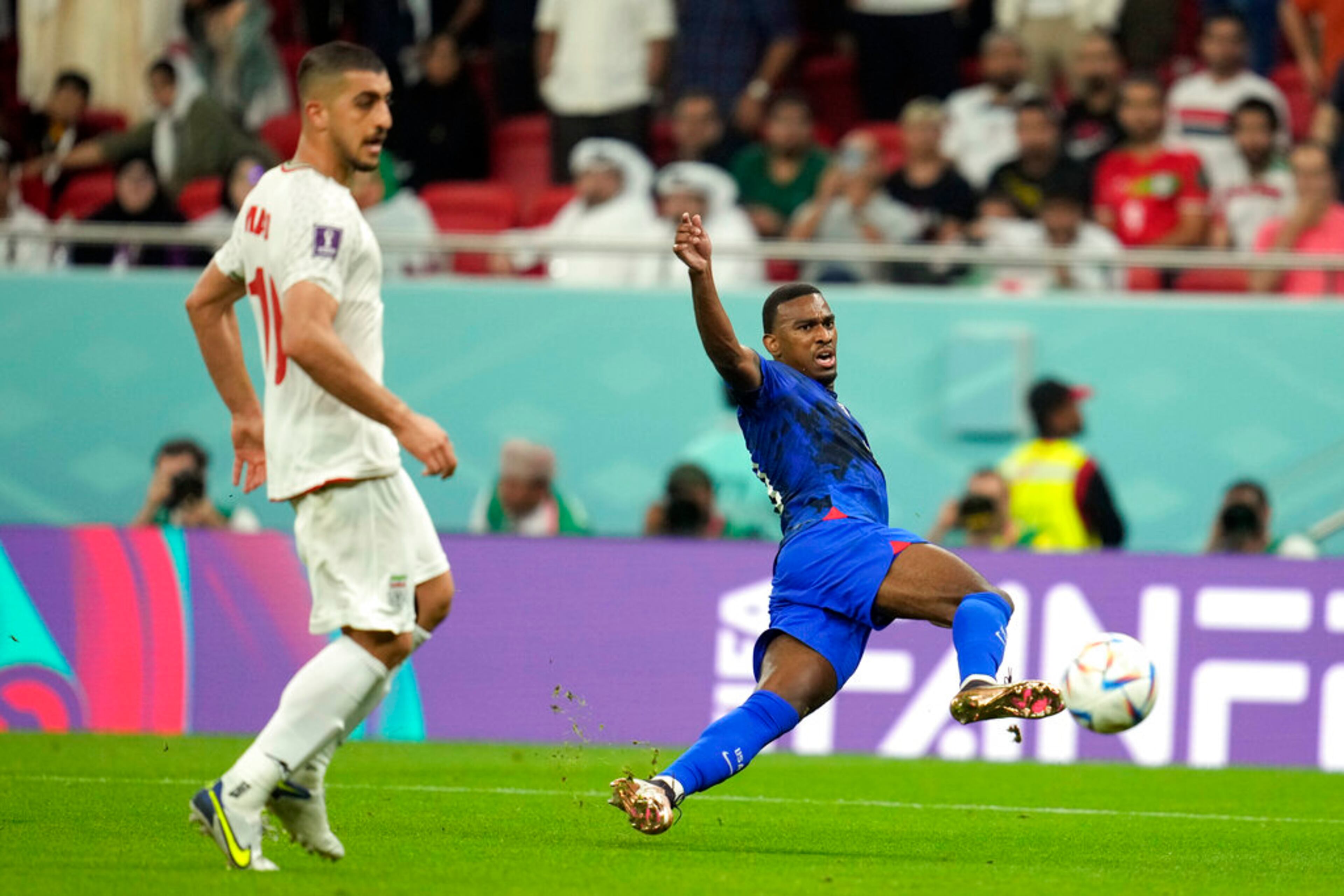 United States' Haji Wright, right, attempts a shot during the World Cup group B soccer match between Iran and the United States at the Al Thumama Stadium in Doha, Qatar, Tuesday, Nov. 29, 2022. (AP Photo/Ashley Landis)