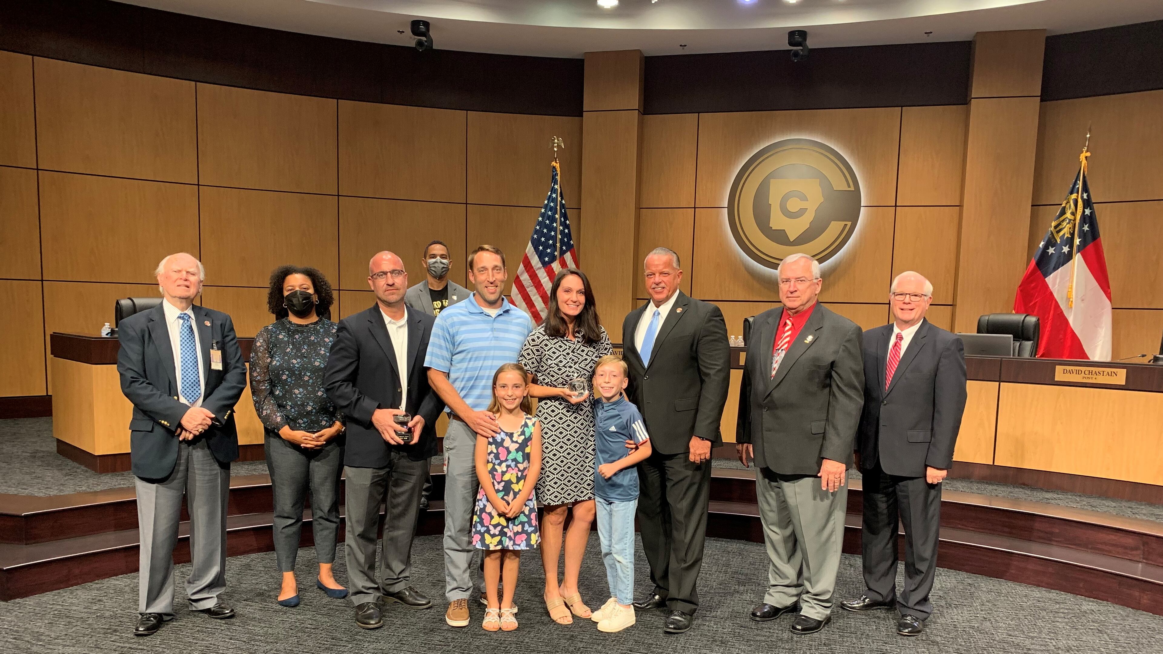 Osborne High School educator Beth Foster, center, was named Cobb County School District's teacher of the year. She was honored by Superintendent Chris Ragsdale and Cobb County School Board members. Credit: Cobb County School District