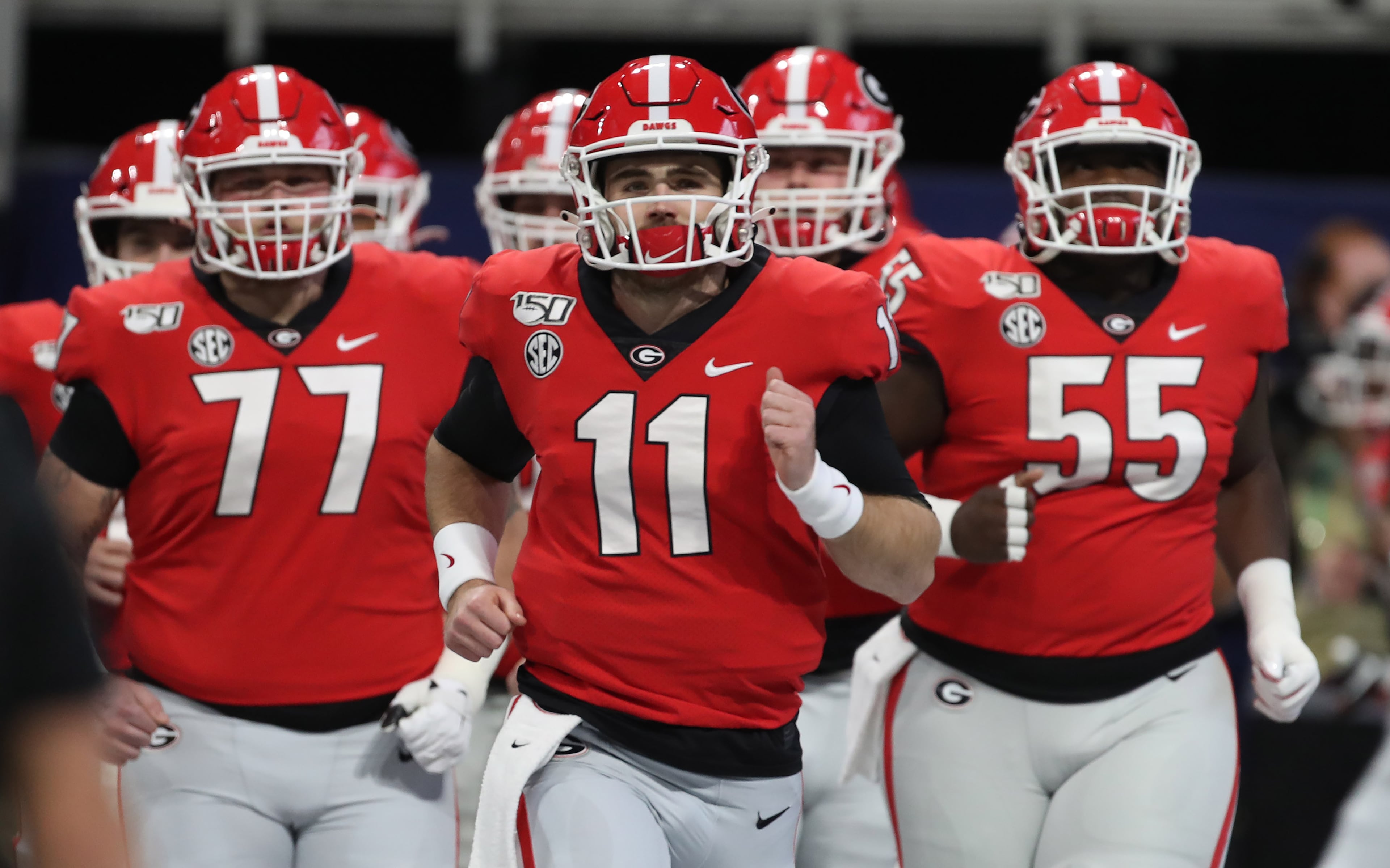 12/7/19 - Atlanta - Georgia Bulldogs quarterback Jake Fromm (11) leads his team onto the field for warmups during the Georgia vs. LSU SEC Football Championship game at Mercedes-Benz Stadium in Atlanta. Alyssa Pointer / alyssa.pointer@ajc.com