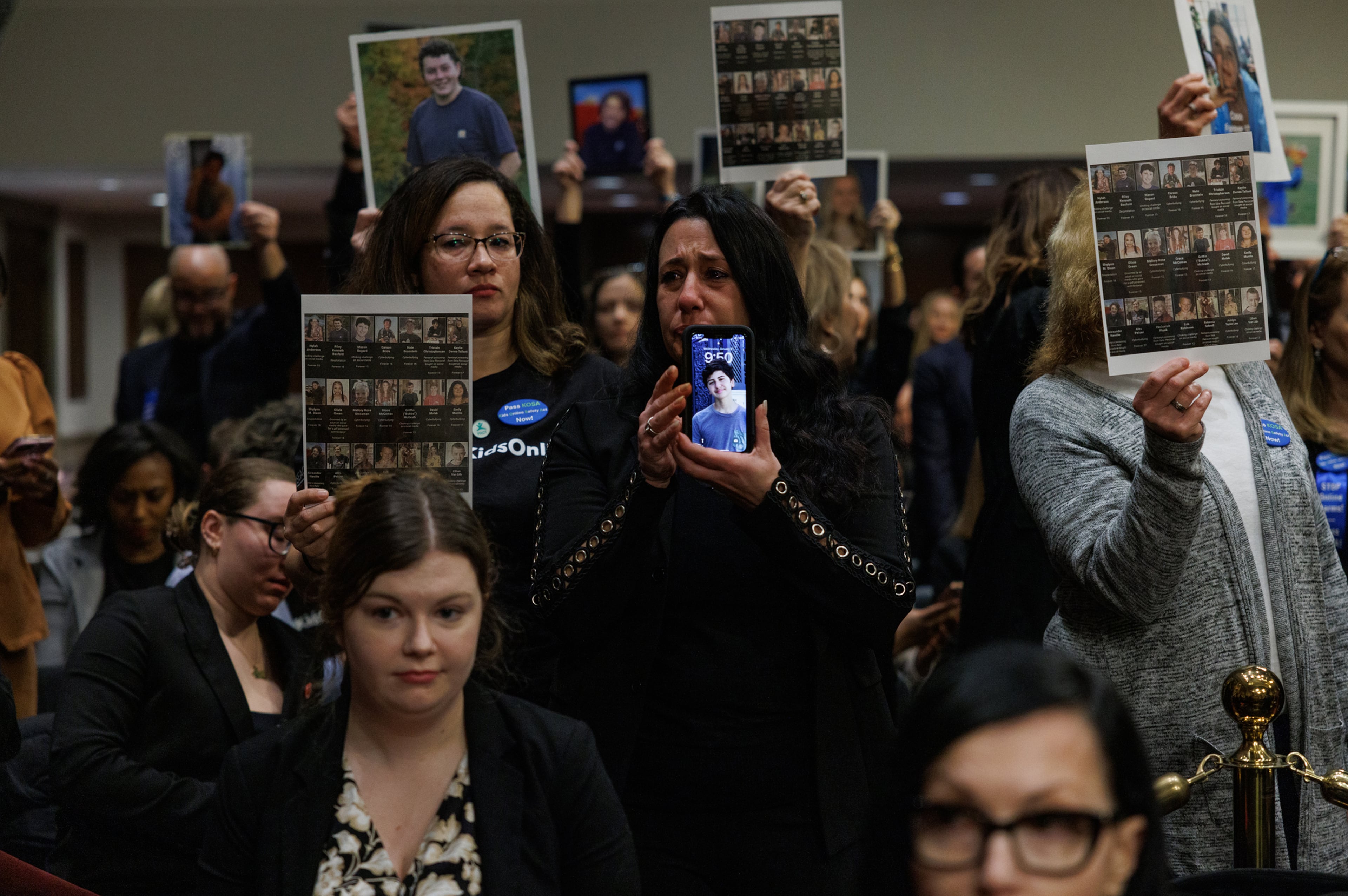 The families of children who were victims of online exploitation and abuse hold up pictures at a Senate Judiciary Committee hearing, where the chief executives of Meta, Snap, Discord, X and TikTok testified, on Capitol Hill in Washington, Jan. 31, 2024. (