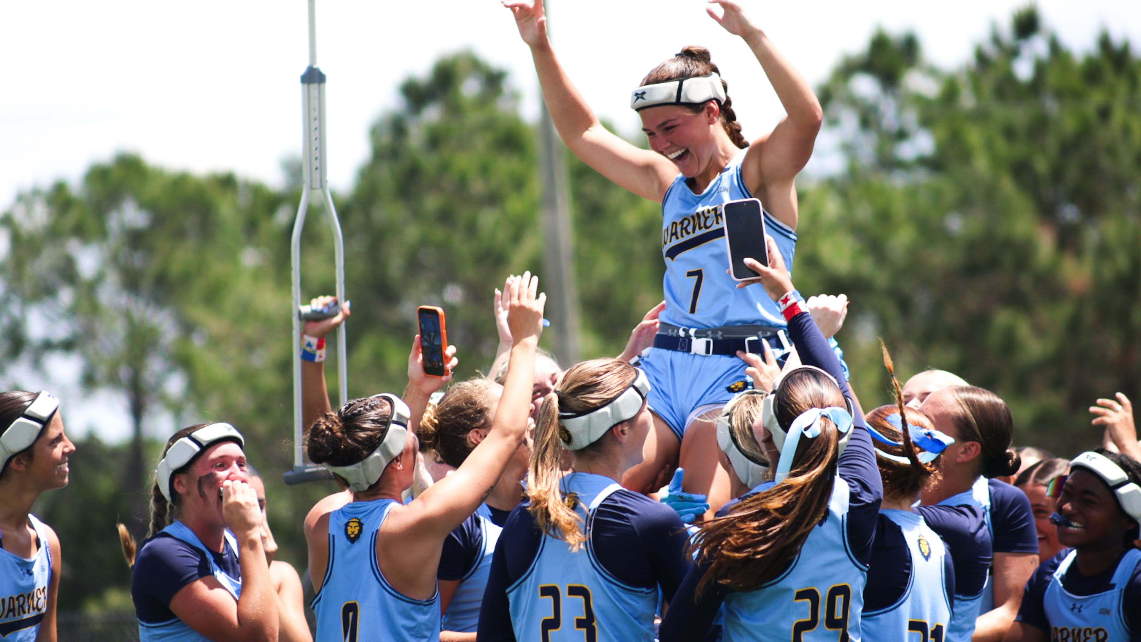 Warner University quarterback Kathryn Hutchinson (top), a River Ridge High grad, celebrates with teammates after the Royals won the Sun Conference Tournament championship Saturday, April 25, 2026, in Lake Wales, Florida. Hutchinson was named tournament MVP after the 25-14 win over Keyser University. (Courtesy of Reese Mole/Warner University)