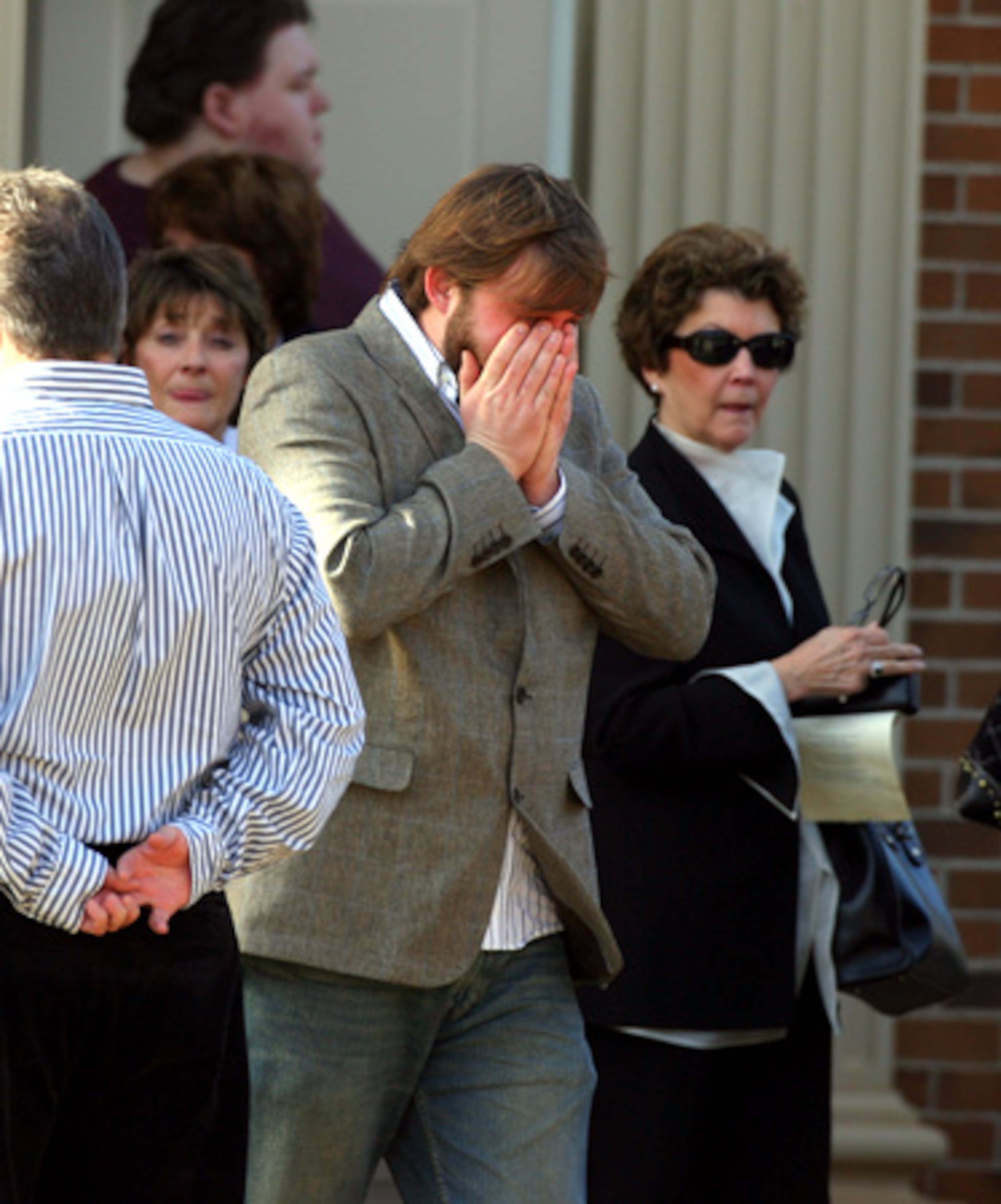 Mourners leave the memorial service.