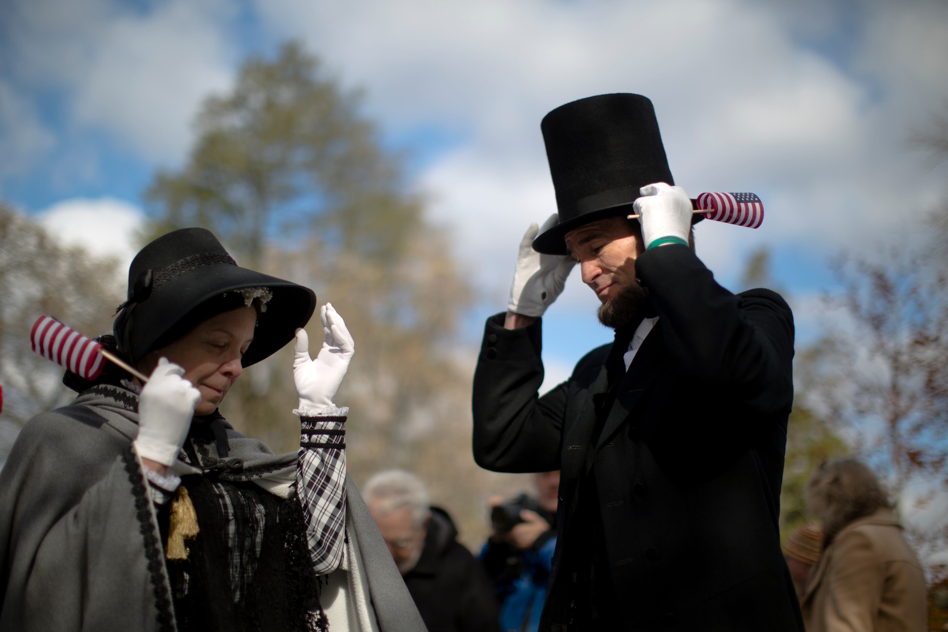 John Voehl portraying President Abraham Lincoln, and wife Pamela, adjust their hats during a ceremony commemorating the 150th anniversary of the dedication of the Soldiers' National Cemetery and President Abraham Lincoln's Gettysburg Address, Tuesday, Nov. 19, 2013, in Gettysburg, Pa. Lincoln's speech was first delivered in Gettysburg nearly five months after the major battle that left tens of thousands of men wounded, dead or missing. (AP Photo/Matt Rourke)