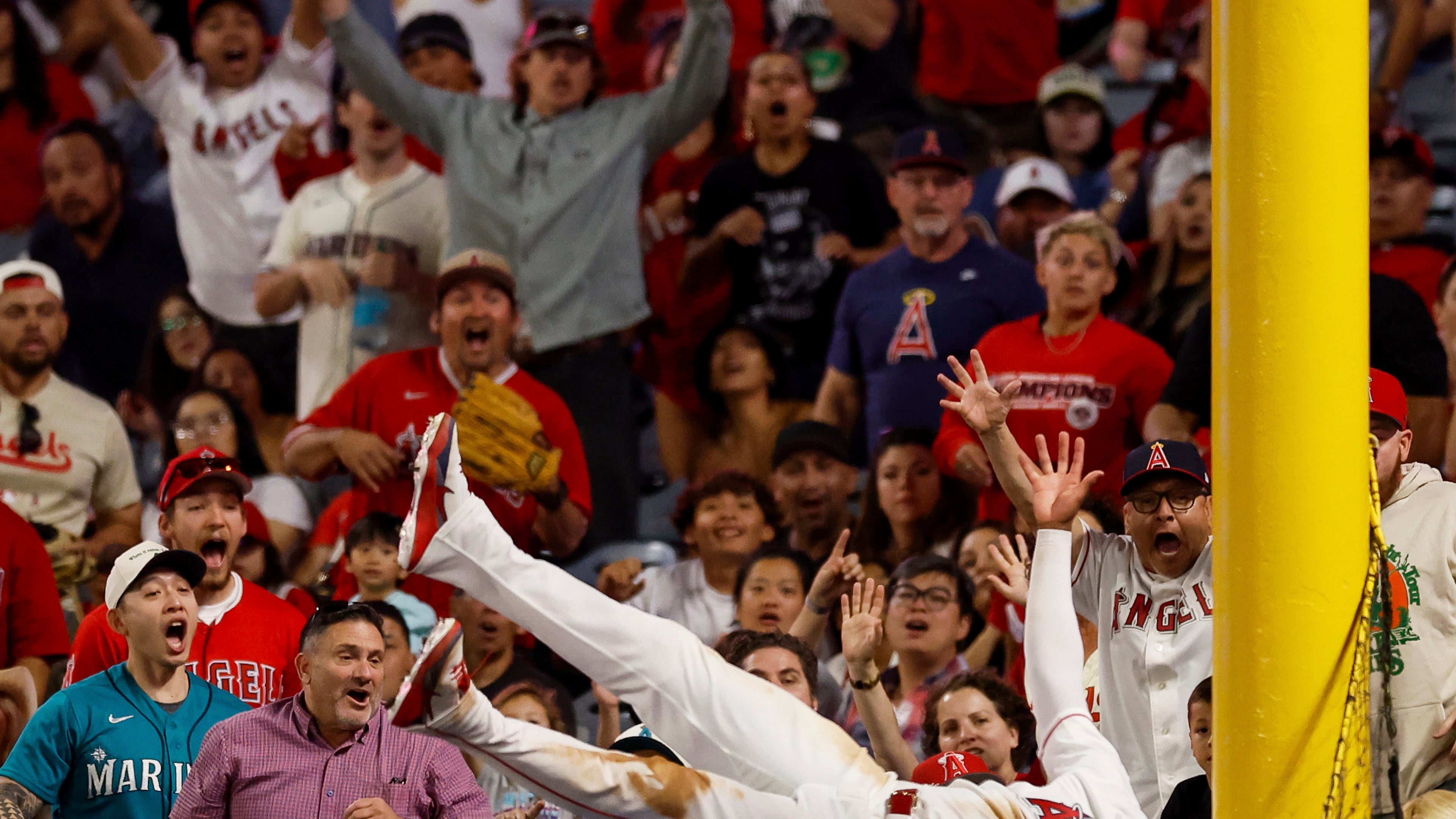 Los Angeles Angels left fielder Jo Adell (7) catches a ball hit by Seattle Mariners' J.P. Crawford during the ninth inning of a baseball game Saturday, April 4, 2026, in Anaheim, Calif. (AP Photo/Caroline Brehman)