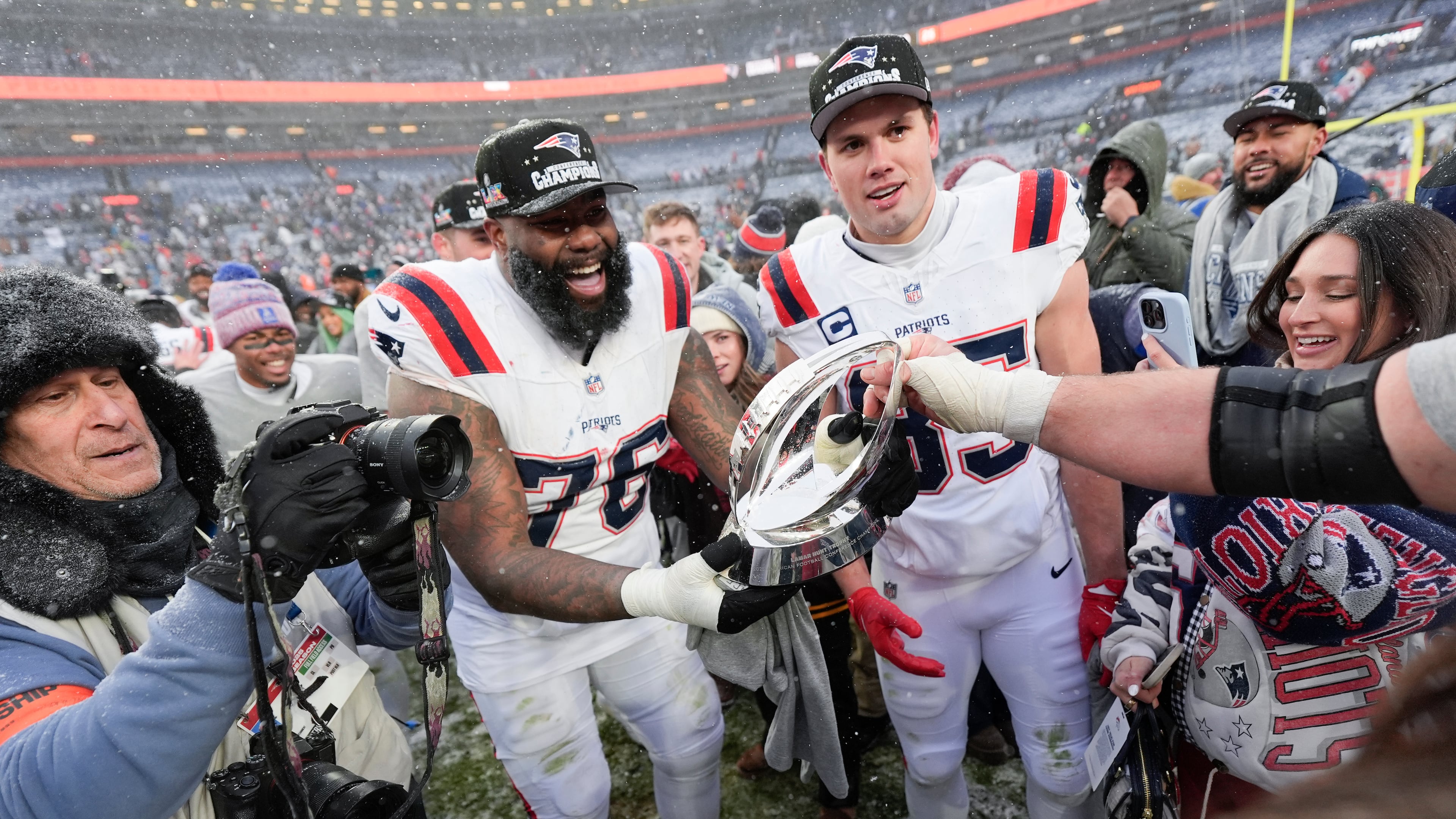 New England Patriots offensive tackle Morgan Moses (76) and tight end Hunter Henry celebrate after the AFC Championship NFL football game against the Denver Broncos, Sunday, Jan. 25, 2026, in Denver. (AP Photo/Ashley Landis)
